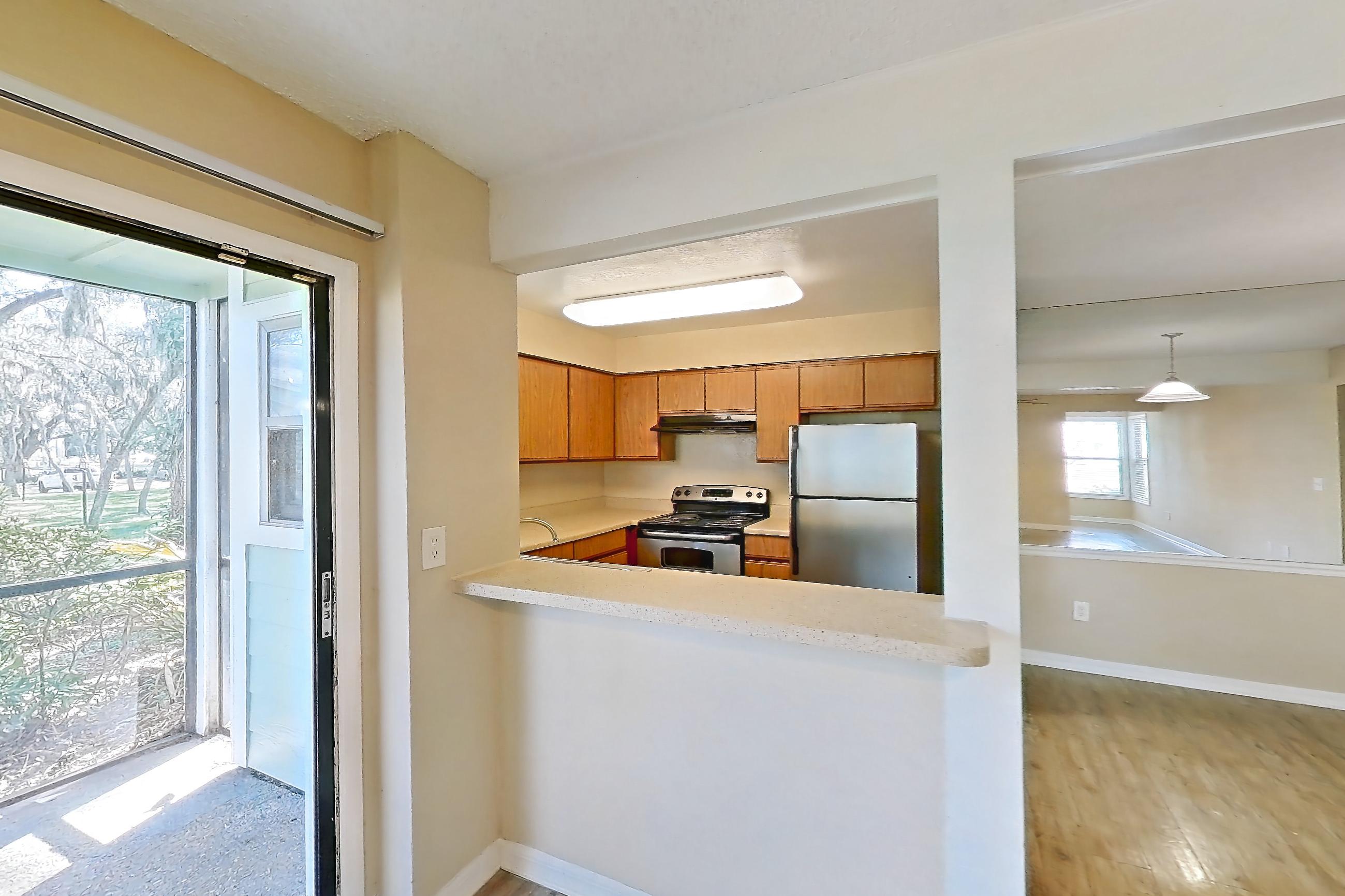 Living space with electric range, light countertops, light wood-finish flooring, oven/range, refrigerator, and stainless steel appliances, Apartment 5021MB at Oak Ramble