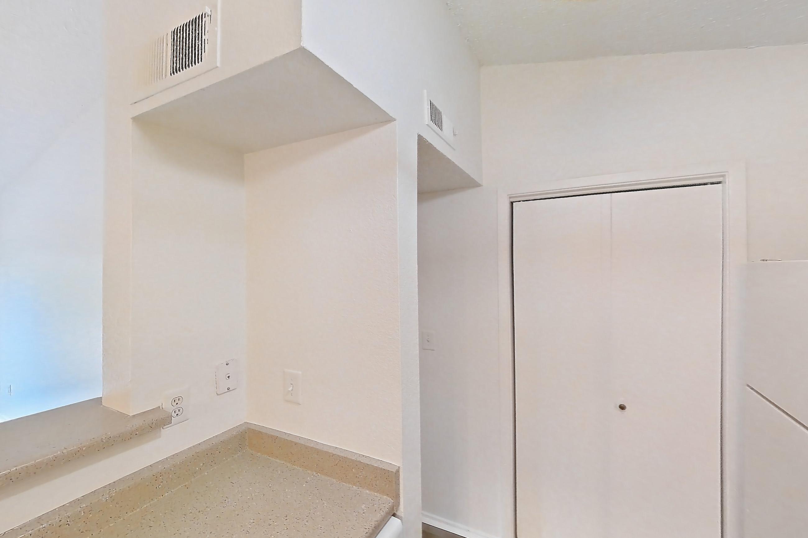 Kitchen with dishwasher, electric range, light countertops, light stone countertops, light wood-finish flooring, microwave, oven/range, refrigerator, and white appliances, Apartment 2621 at Canyon Chase