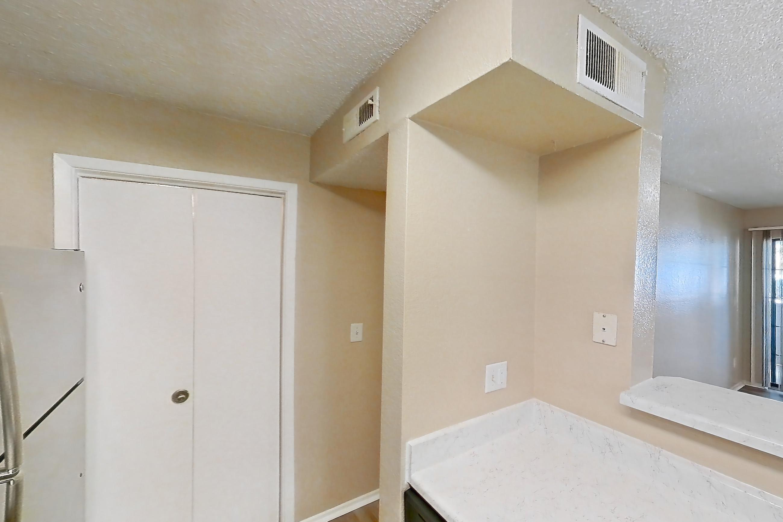 Kitchen with dishwasher, electric range, light countertops, light stone countertops, light wood-finish flooring, microwave, oven/range, refrigerator, and stainless steel appliances, Apartment 3514 at Canyon Chase