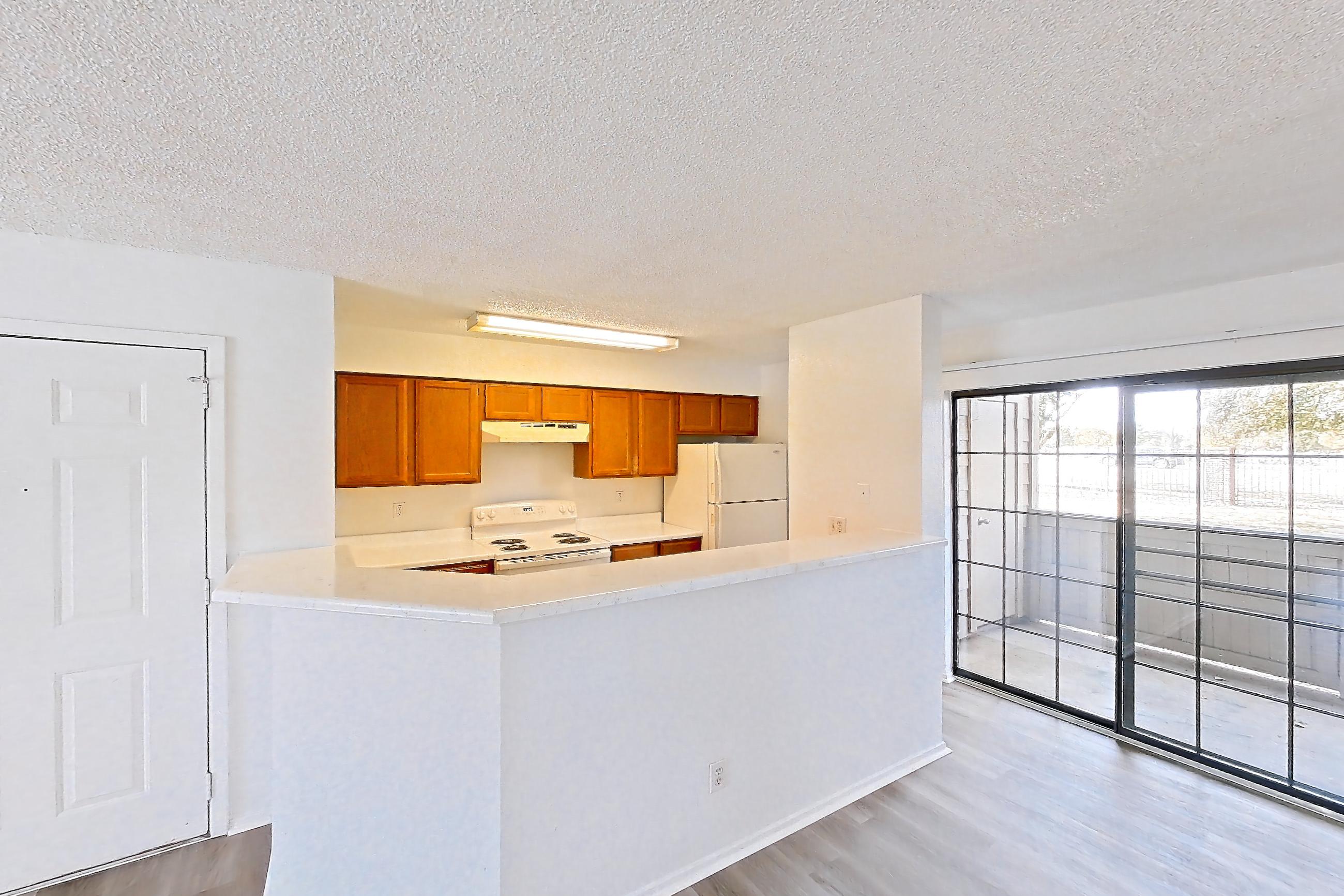 Living space with electric range, light countertops, light wood-finish flooring, oven/range, refrigerator, and white appliances, Apartment 4214 at Canyon Chase
