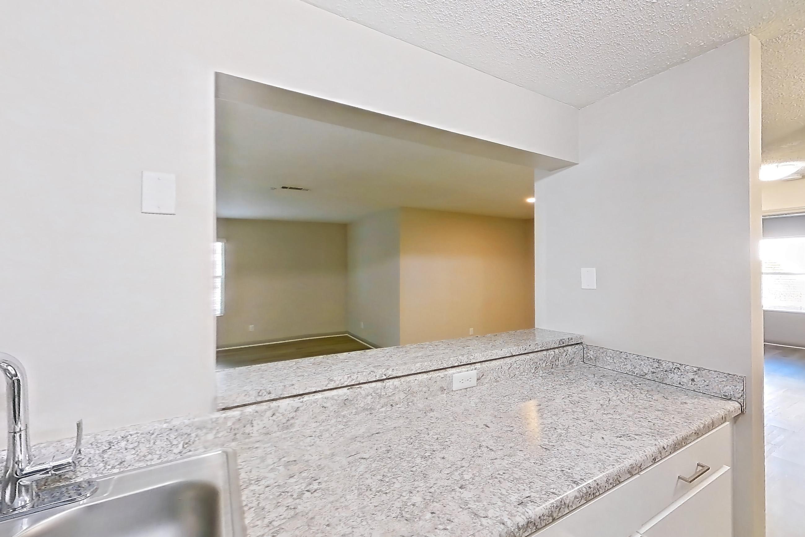 Kitchen with dishwasher, electric range, light countertops, light wood-finish flooring, oven/range, and stainless steel appliances, Apartment 61-A02 at Crosstown at Chapel Hill