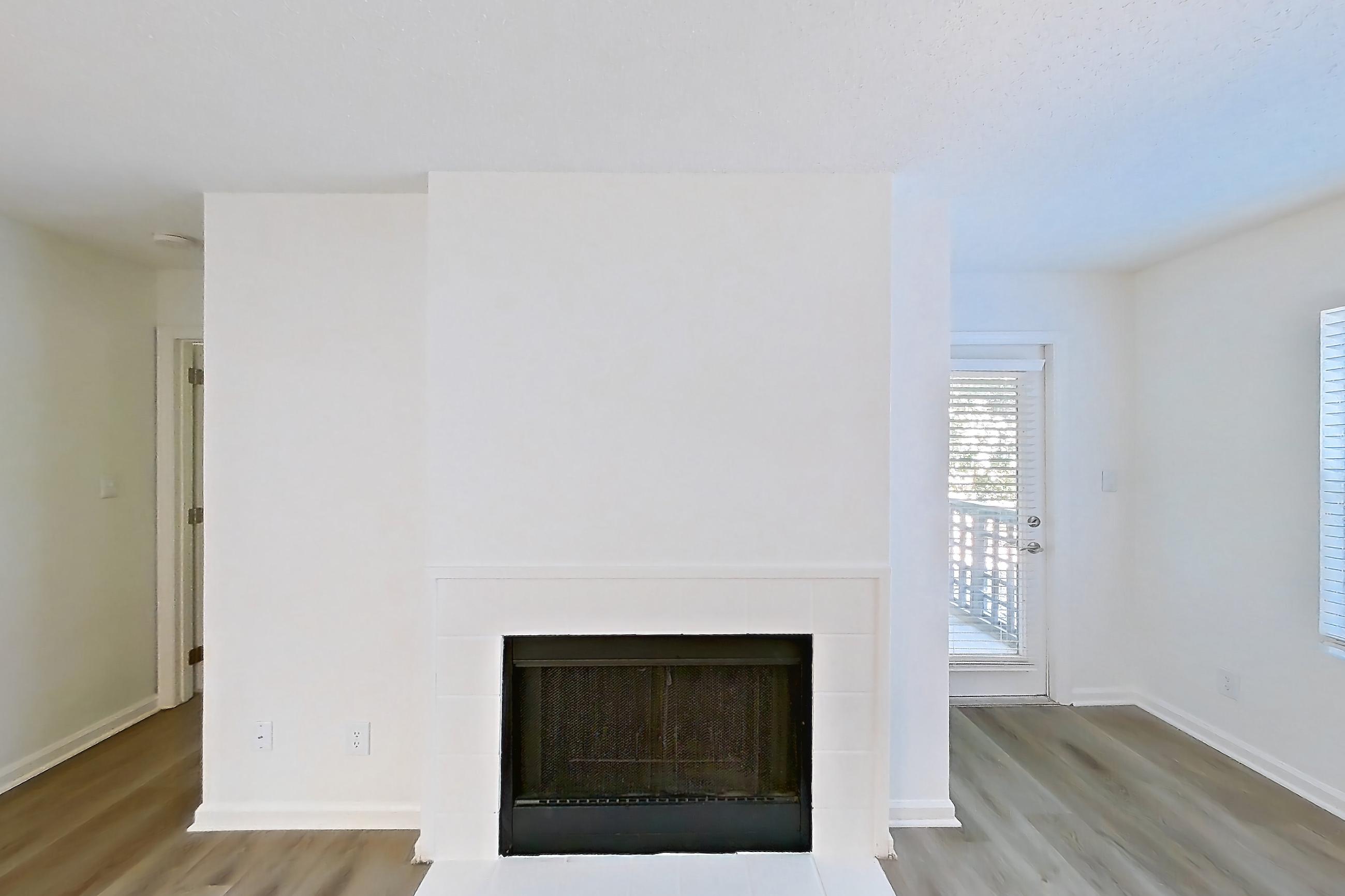 Living room with dark wood-finish flooring, fireplace, light wood-finish flooring, and tile fireplace, Apartment 61-B08 at Crosstown at Chapel Hill