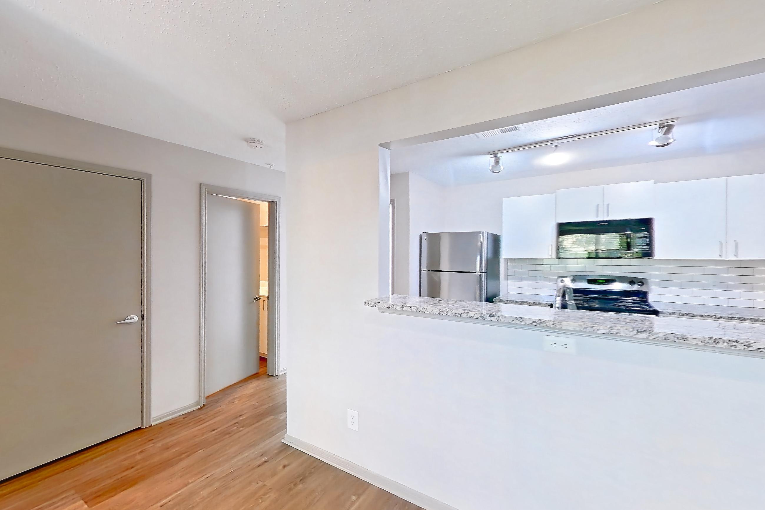 Dining room with oven/range, refrigerator, and stainless steel appliances, Apartment 62-D08 at Crosstown at Chapel Hill