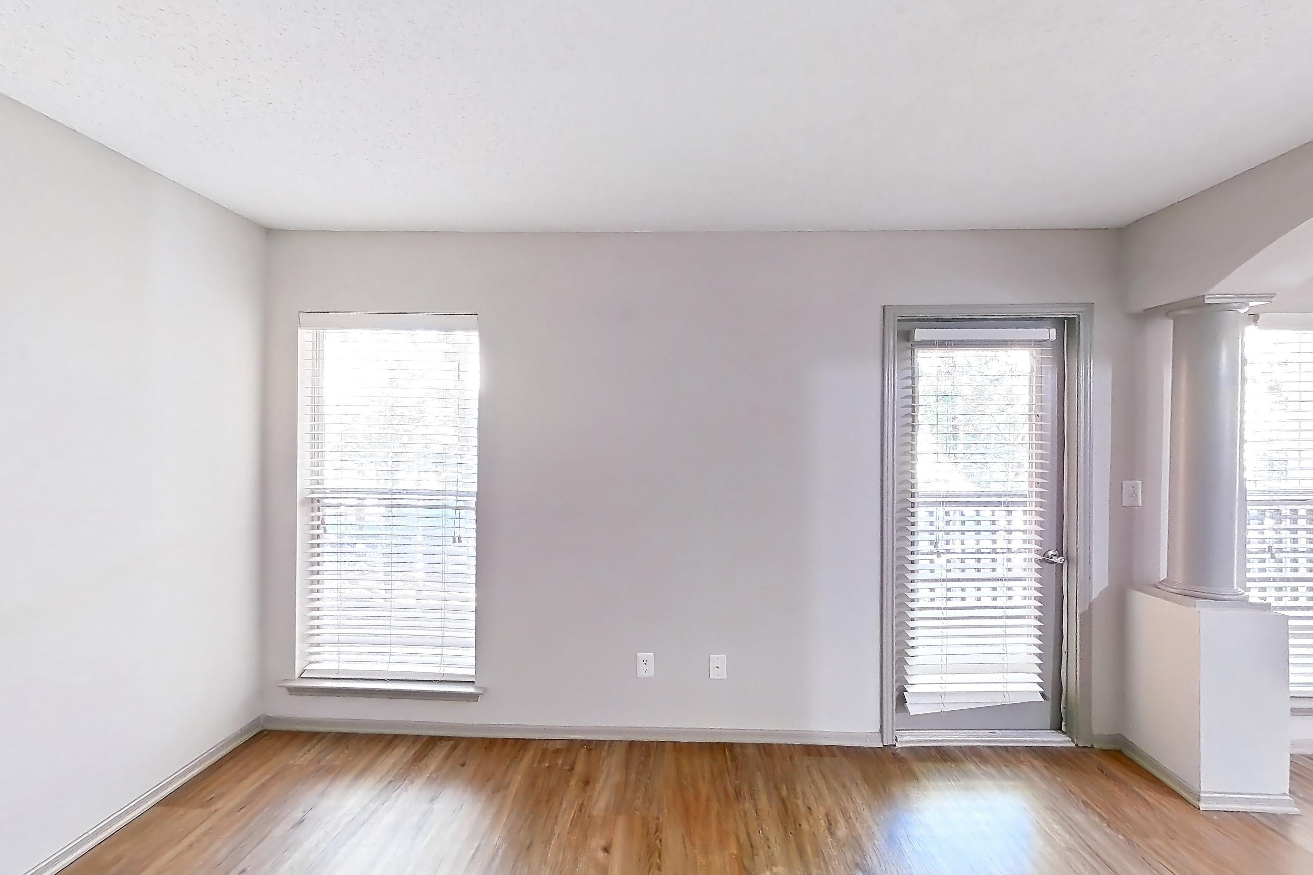 Living room with electric range, light countertops, light wood-finish flooring, oven/range, and stainless steel appliances, Apartment 62-D08 at Crosstown at Chapel Hill