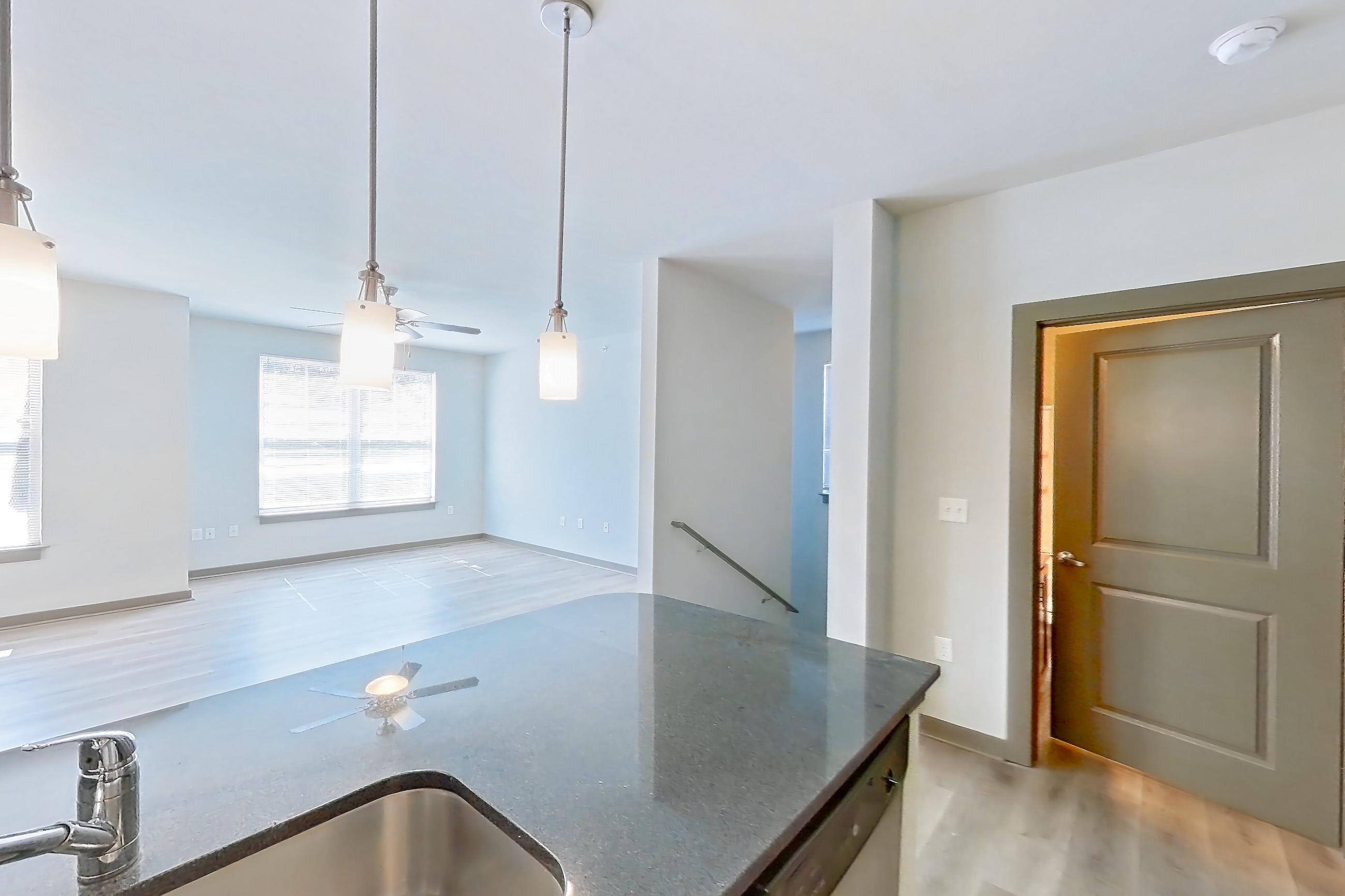 Kitchen with dark stone countertops, dishwasher, electric range, light wood-finish flooring, microwave, oven/range, refrigerator, and stainless steel appliances, Apartment 800-206G at Park 9