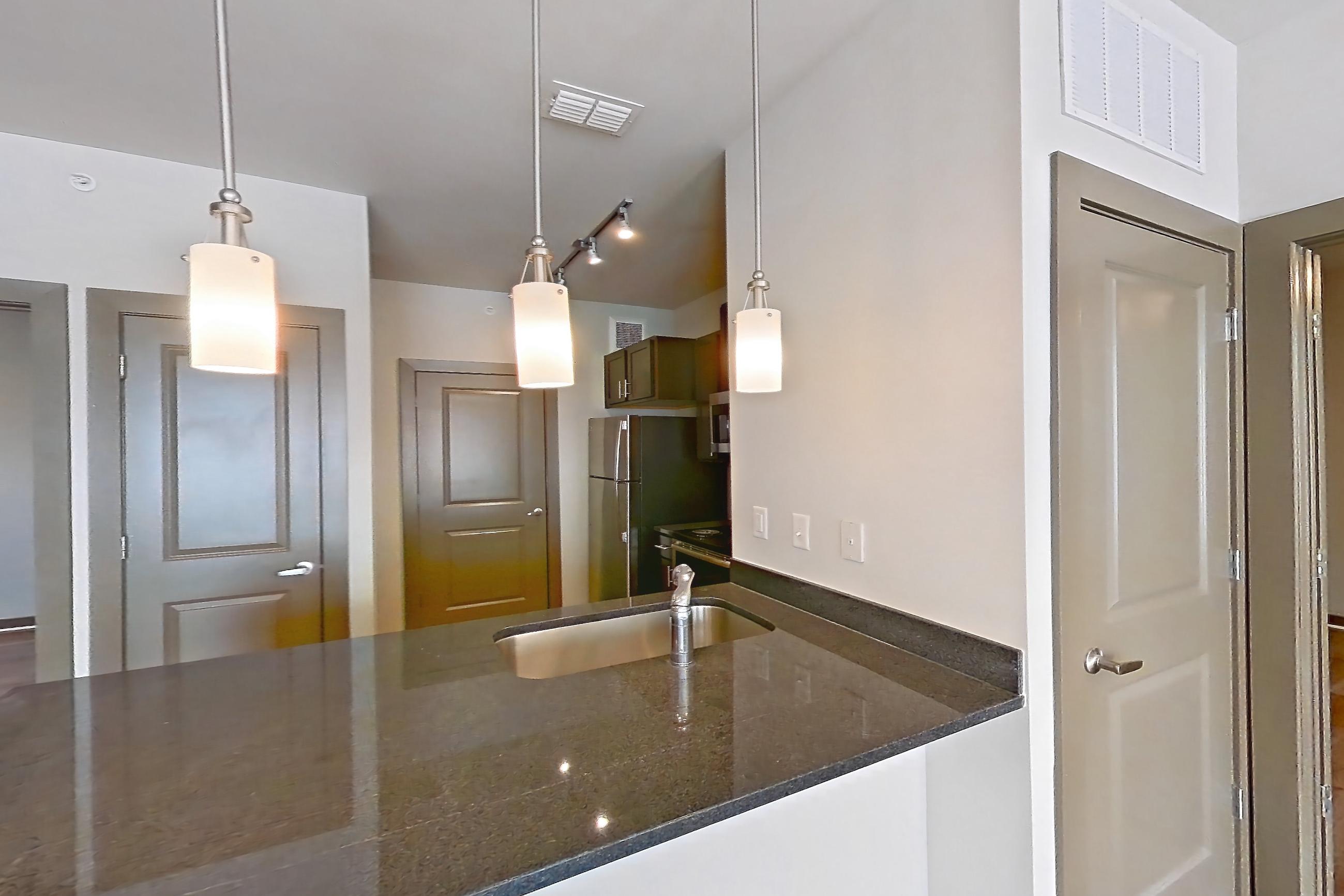 Living space with dark stone countertops, electric range, light wood-finish flooring, refrigerator, and stainless steel appliances, Apartment 800-206G at Park 9