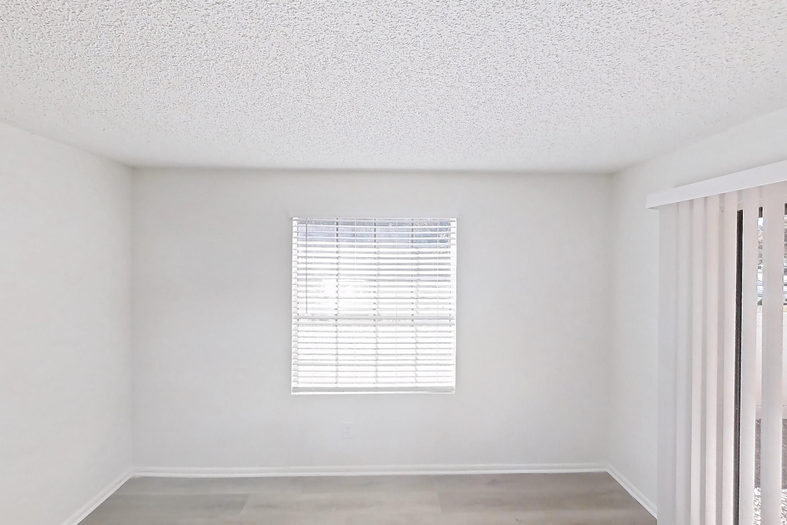 Living space with light wood-finish flooring, Apartment 09-106 at St. James Crossing