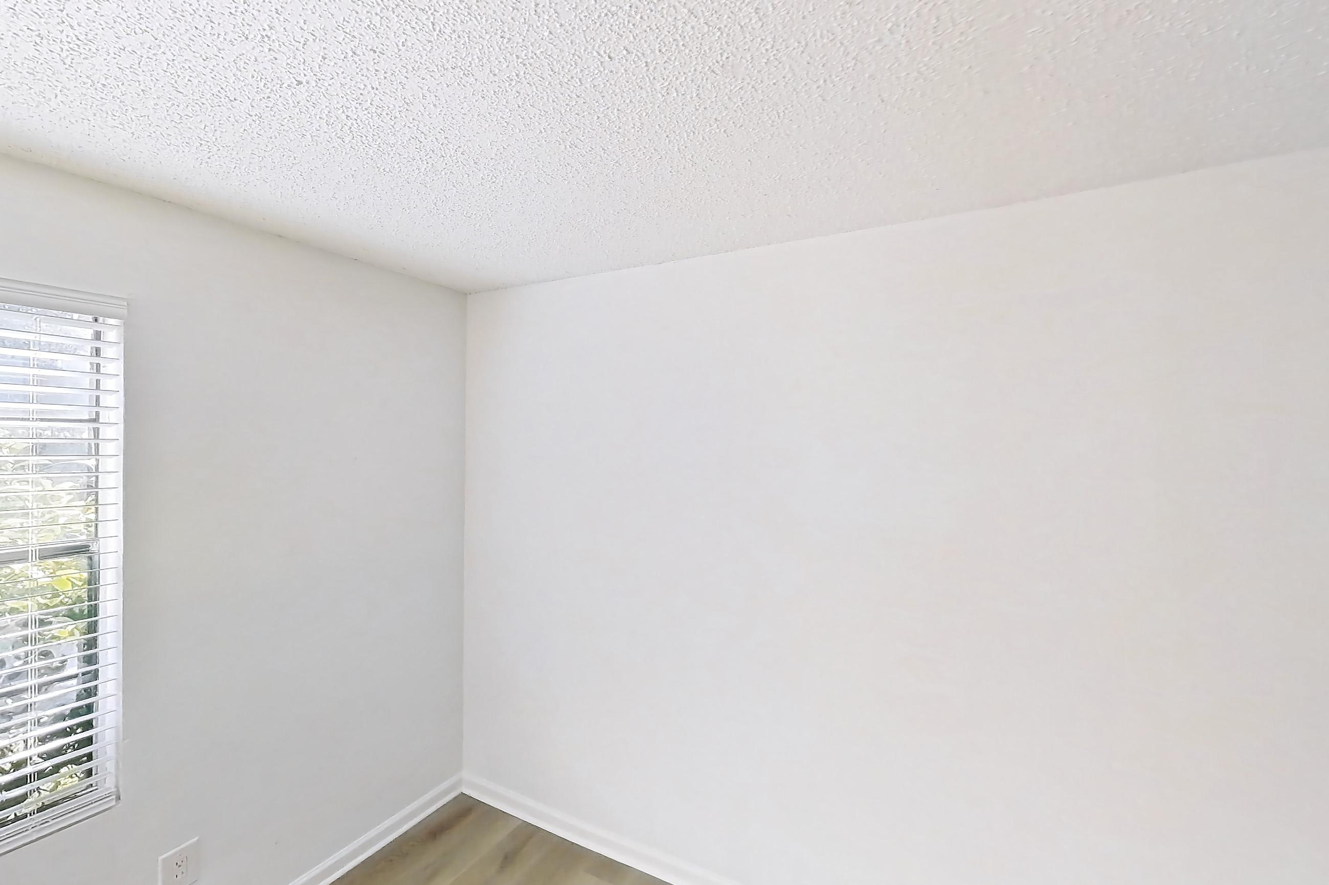 Living room with light wood-finish flooring, Apartment 19-105 at St. James Crossing