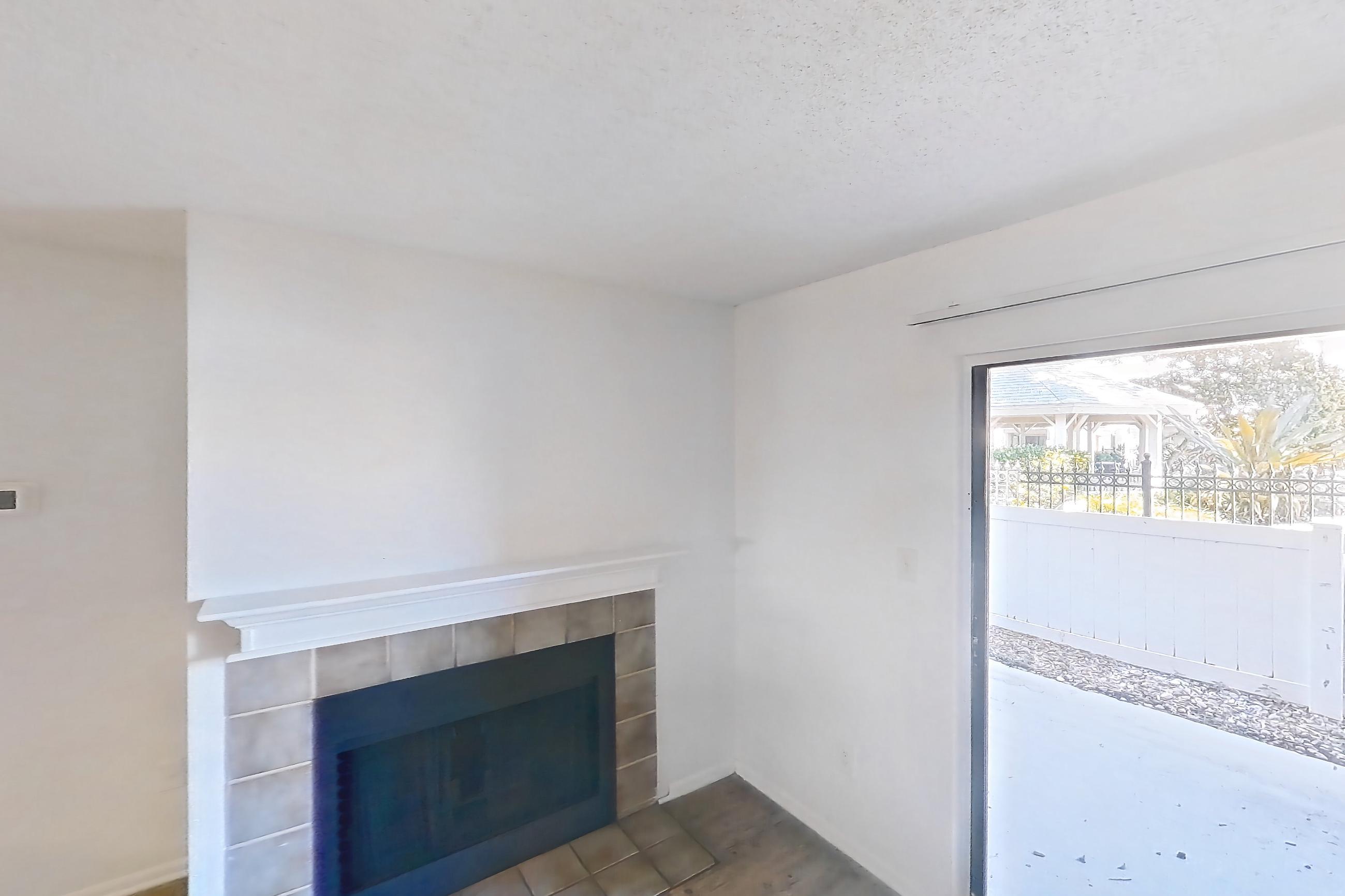 Living room with fireplace and tile fireplace, Apartment 09-108 at St. James Crossing