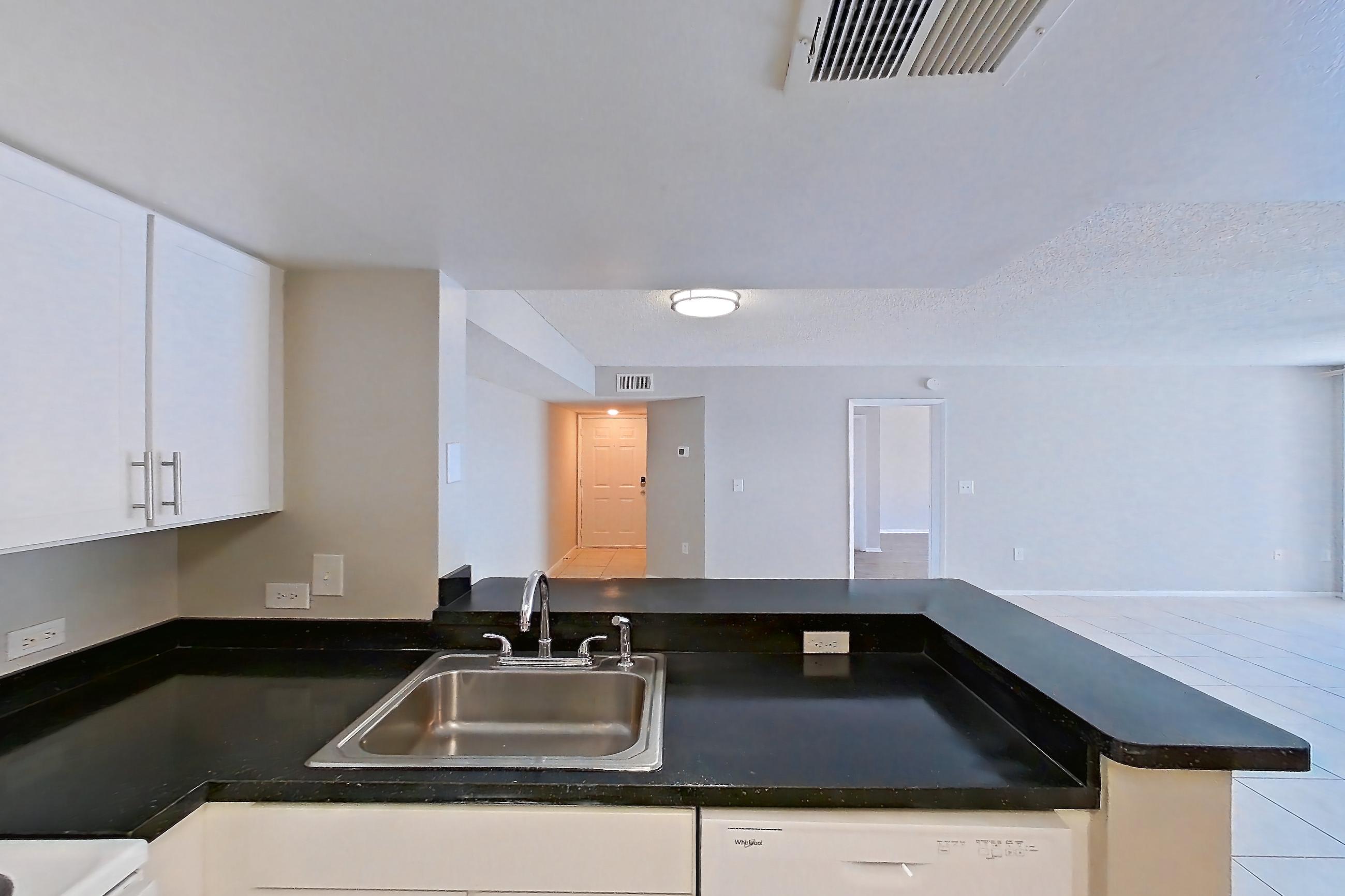 Kitchen with dark countertops, dishwasher, electric range, light tile flooring, microwave, oven/range, and white appliances, Apartment 01-11838 at Sabal Pointe