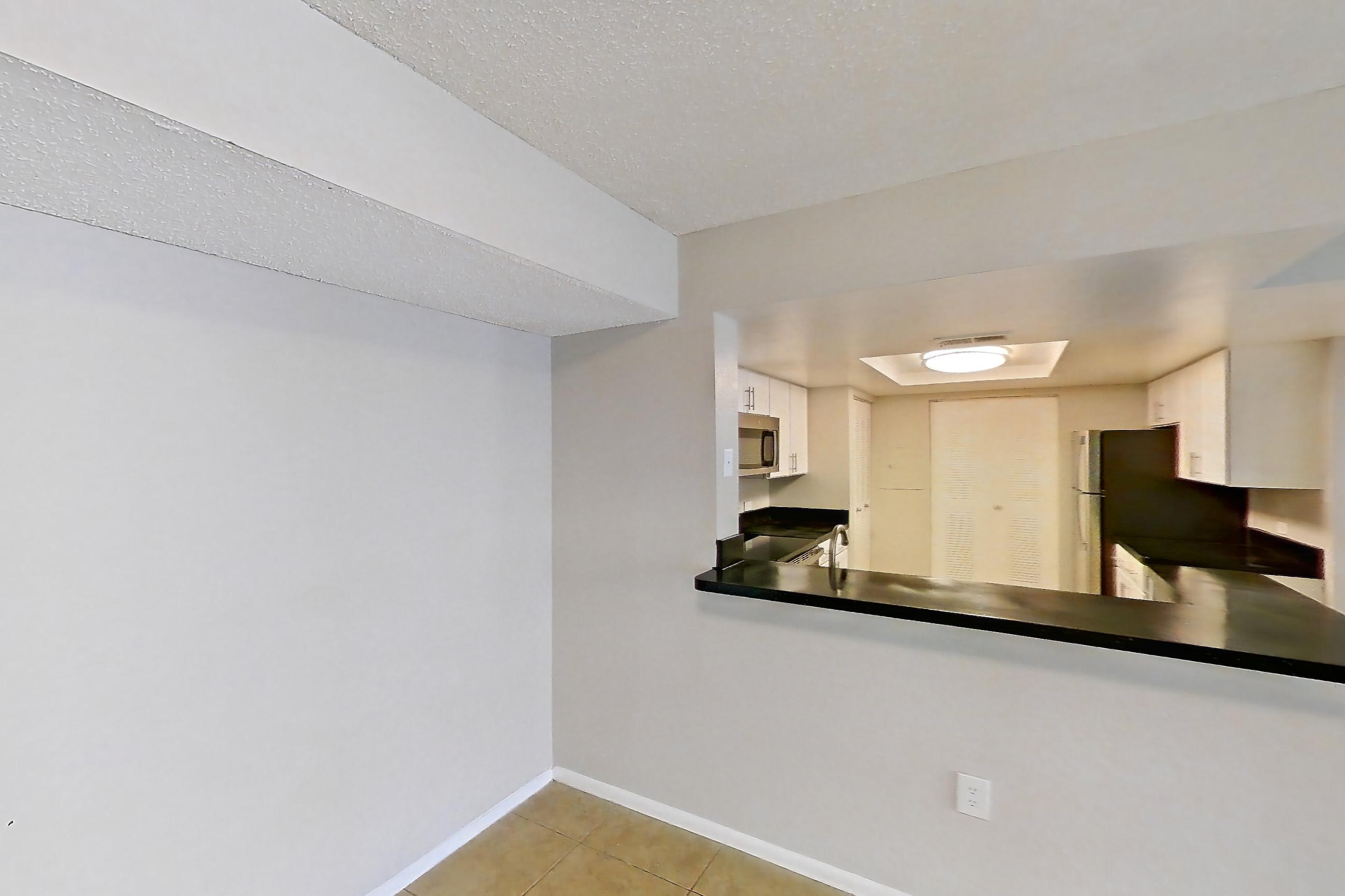 Living space with dark countertops and light tile flooring, Apartment 03-11932 at Sabal Pointe