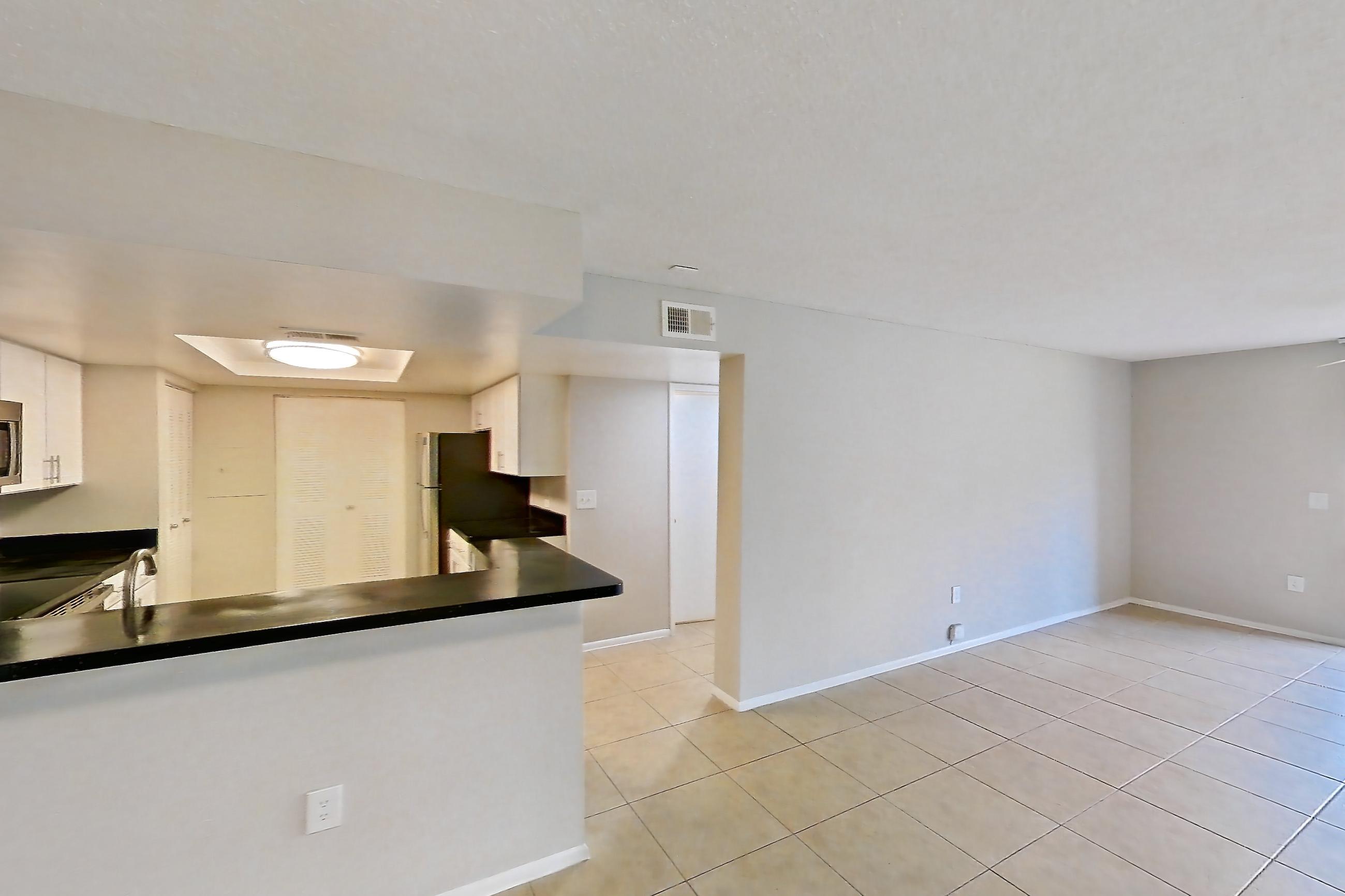 Living space with dark countertops and light tile flooring, Apartment 03-11932 at Sabal Pointe