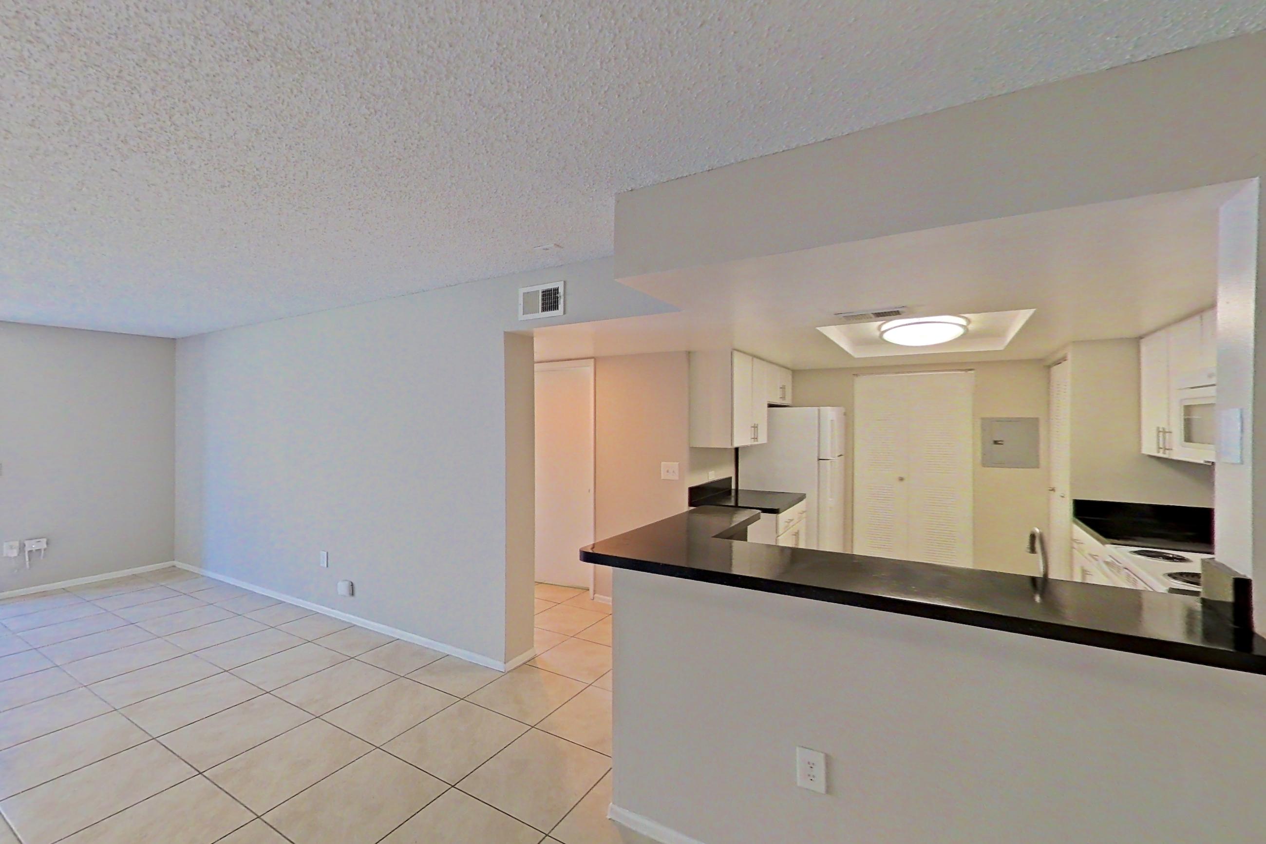 Living space with dark countertops, electric range, light tile flooring, oven/range, refrigerator, and white appliances, Apartment 03-11934 at Sabal Pointe