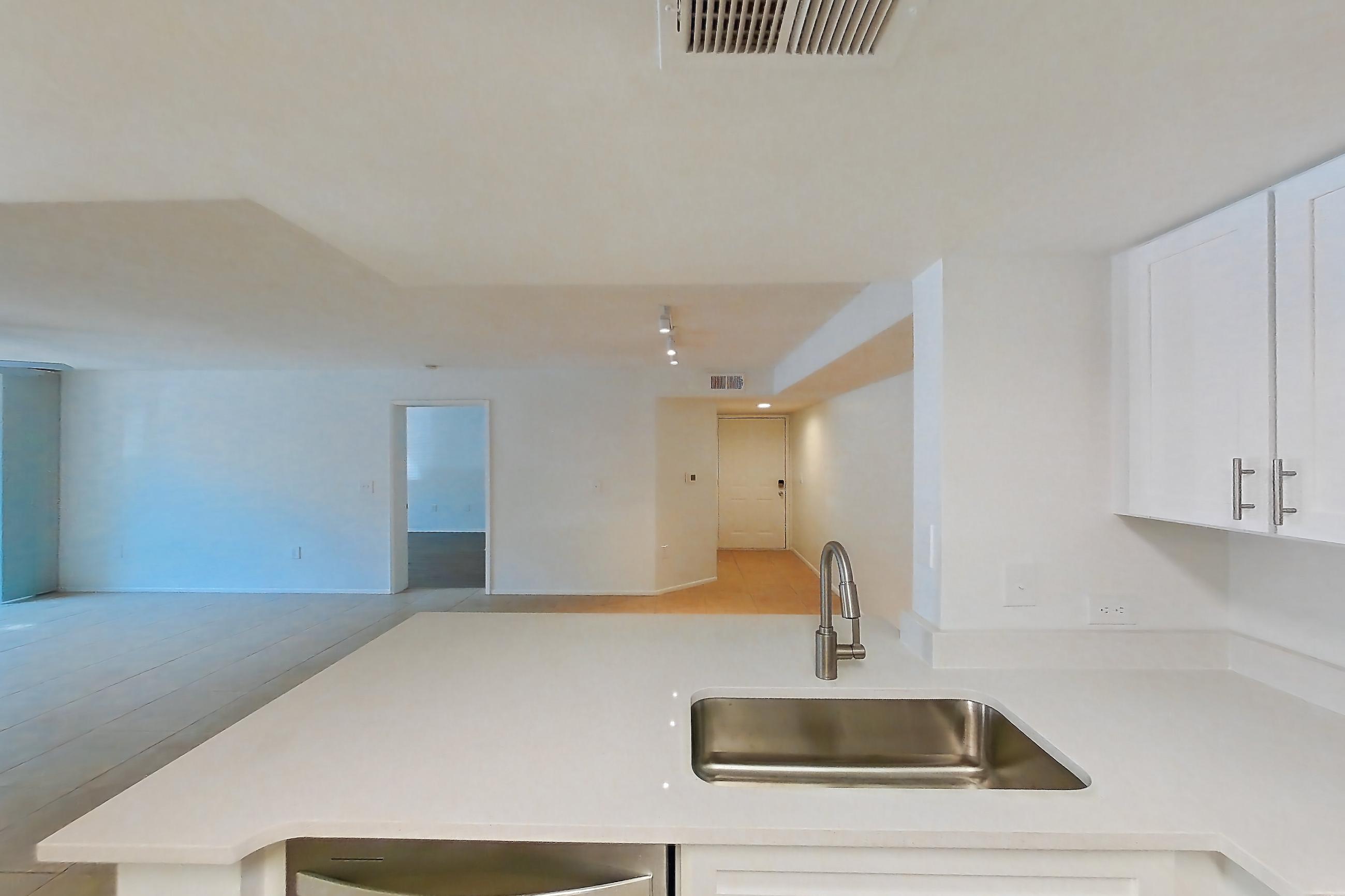 Kitchen with dishwasher, electric range, light countertops, light stone countertops, light tile flooring, microwave, oven/range, refrigerator, and stainless steel appliances, Apartment 06-12074 at Sabal Pointe