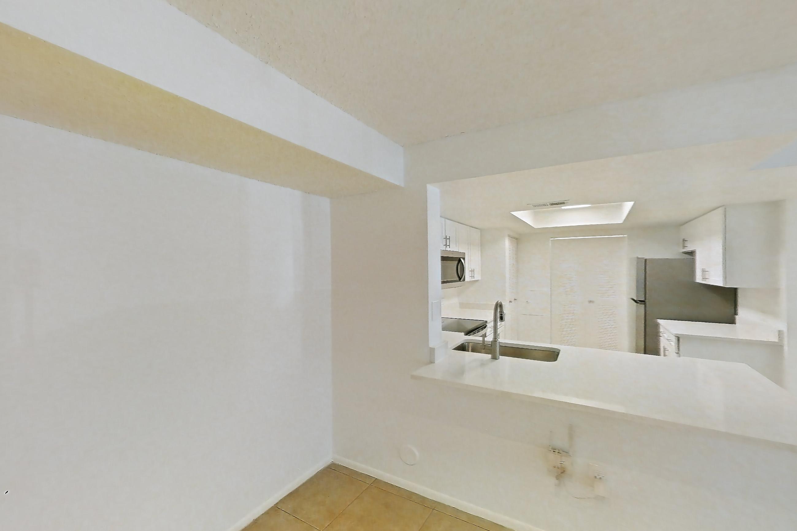 Living space with light countertops, light tile flooring, refrigerator, and white appliances, Apartment 06-12074 at Sabal Pointe