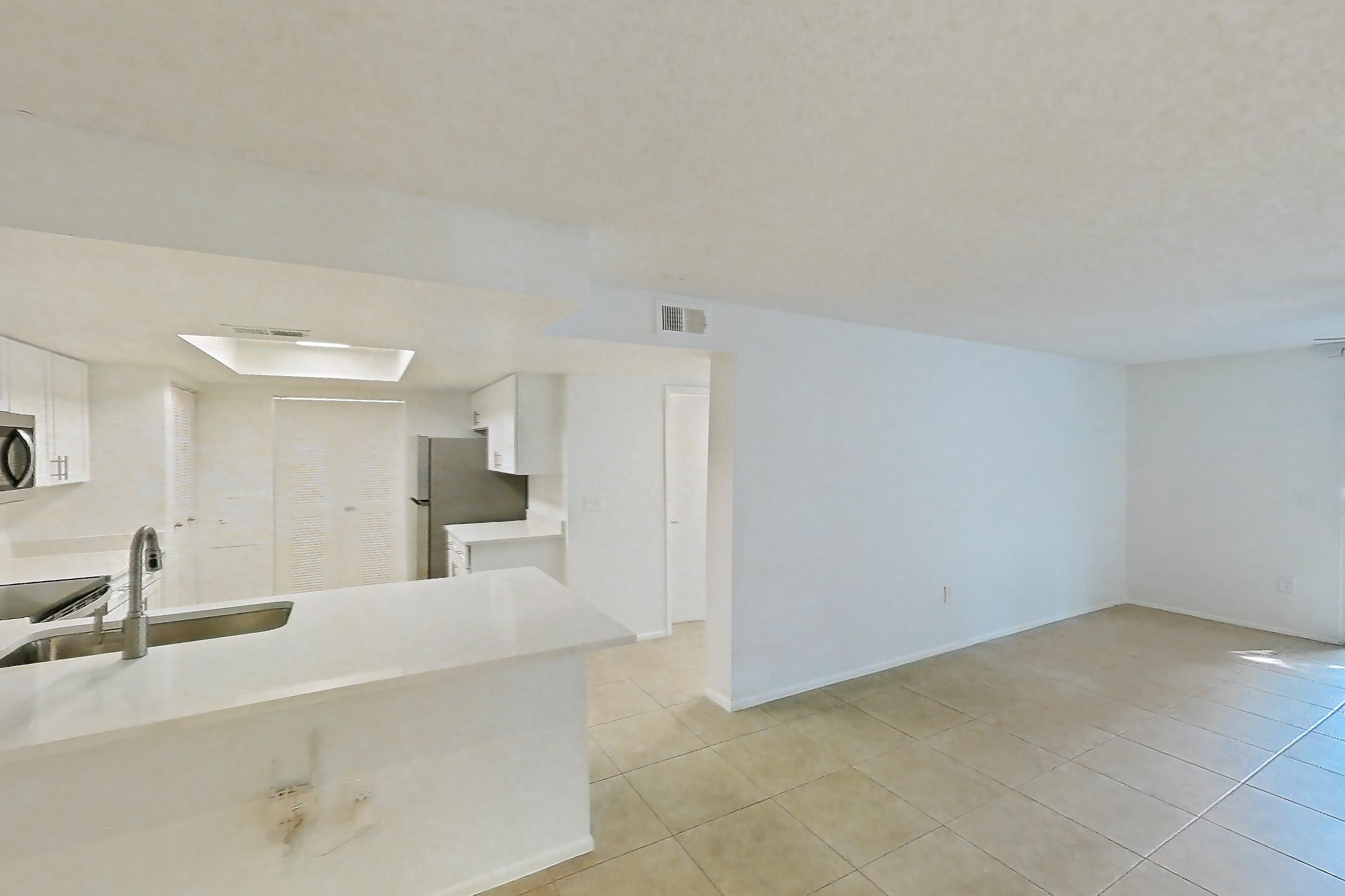 Living space with light countertops, light tile flooring, refrigerator, and white appliances, Apartment 06-12074 at Sabal Pointe