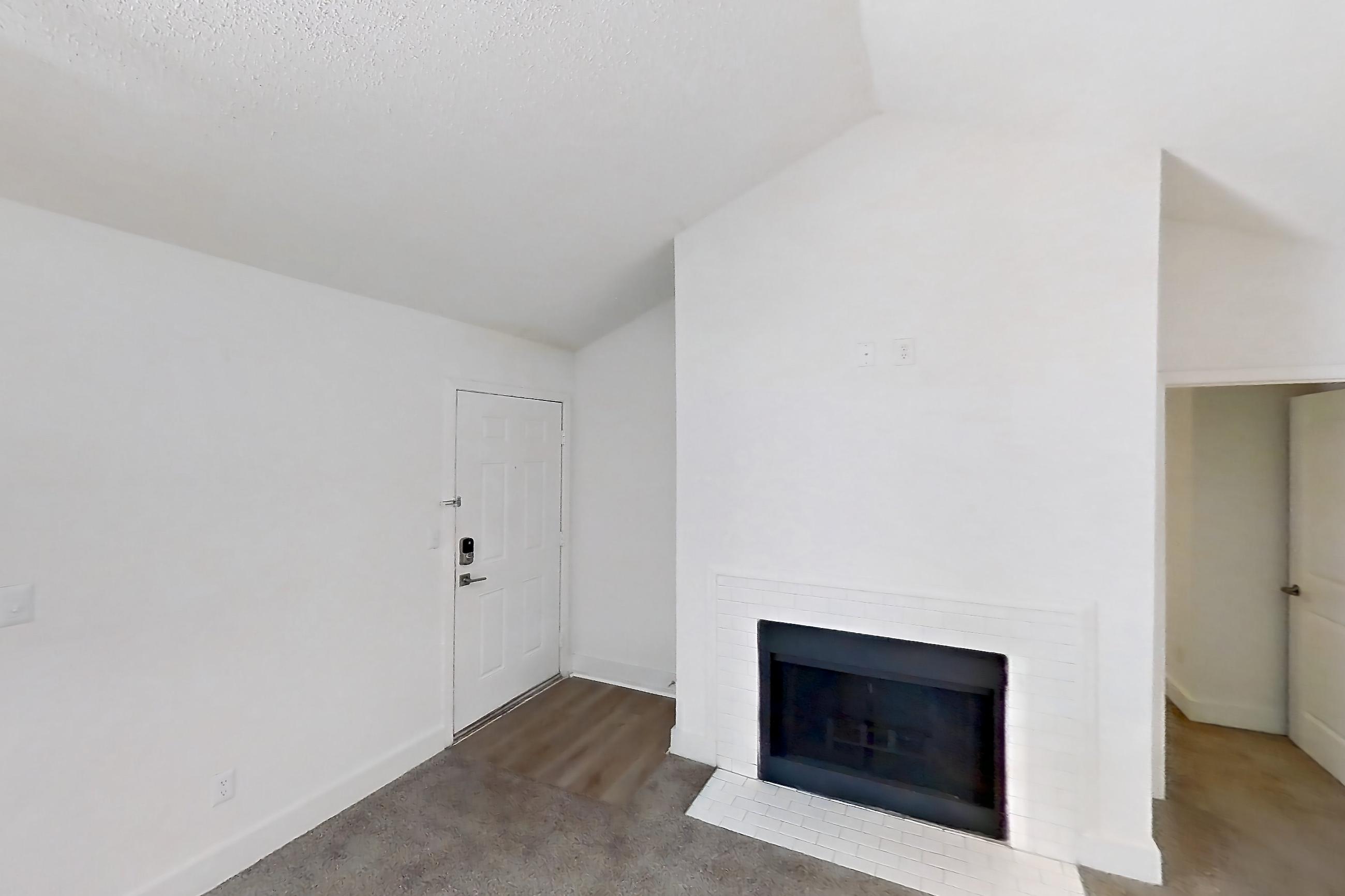Living room with brick fireplace and fireplace, Apartment 20-207 at St. James Crossing