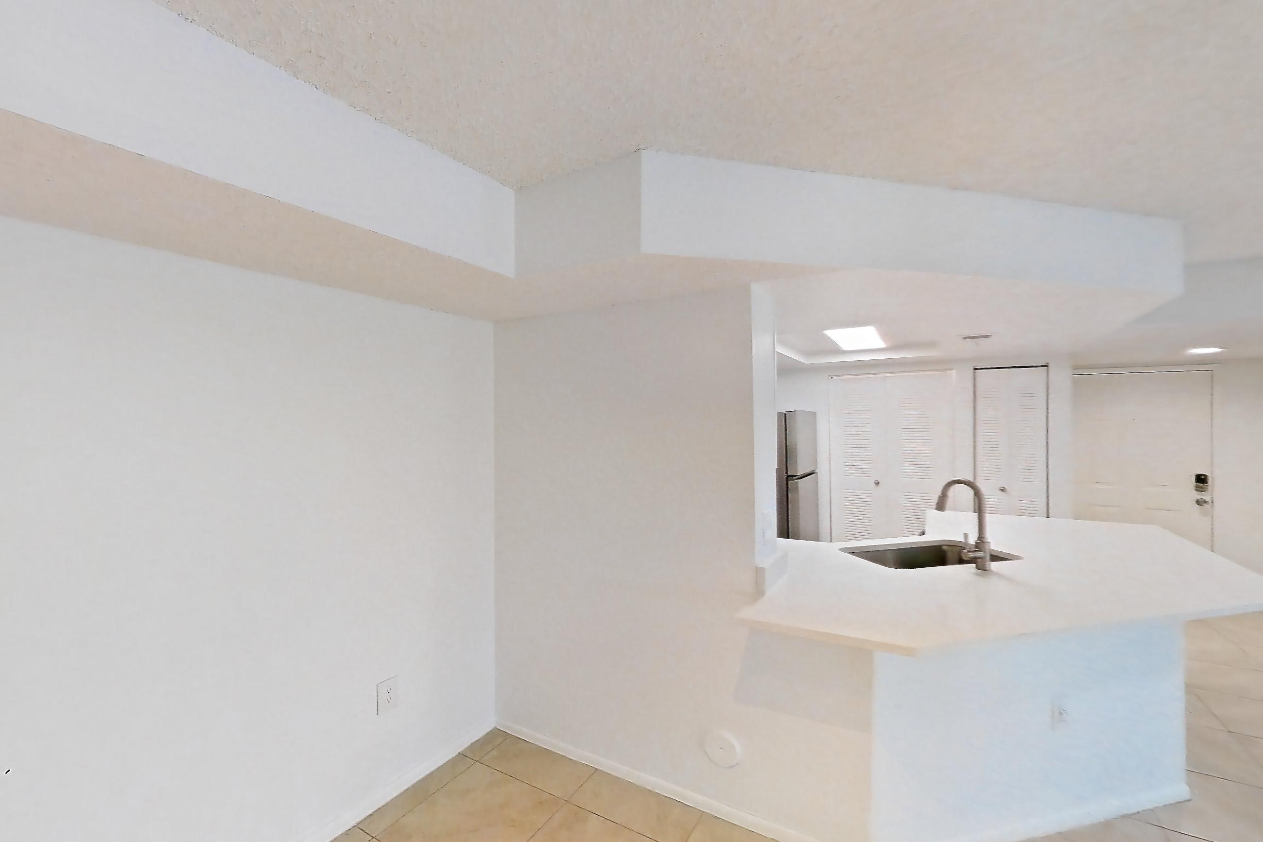 Living space with light countertops, light tile flooring, refrigerator, and white appliances, Apartment 09-12244 at Sabal Pointe