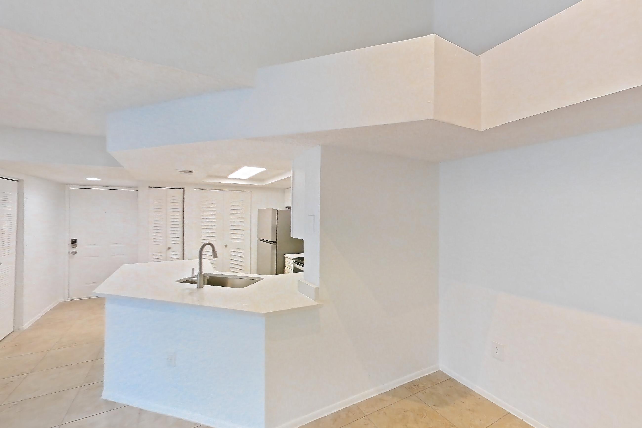 Living space with light countertops, light tile flooring, oven/range, and stainless steel appliances, Apartment 09-12234 at Sabal Pointe