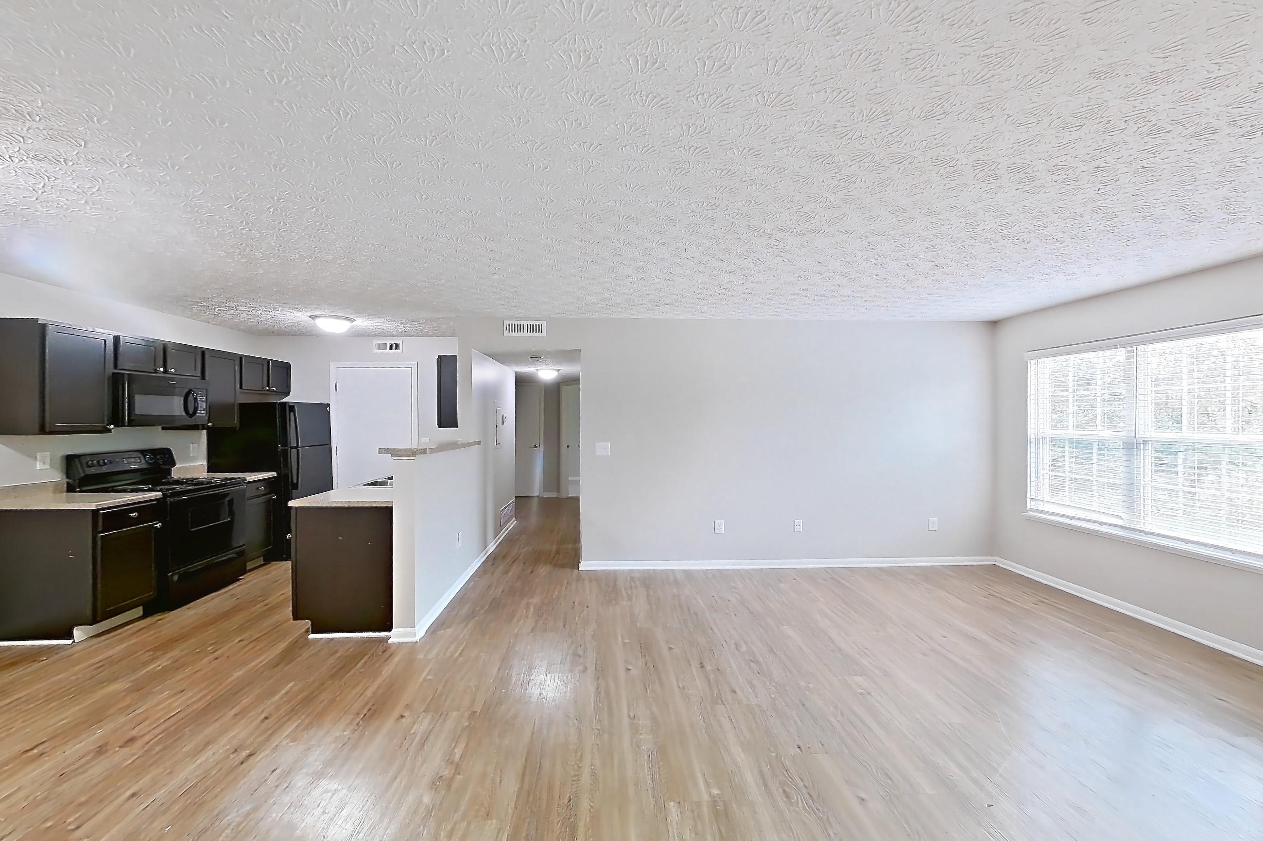 Living space with black appliances, electric range, light wood-finish flooring, oven/range, and refrigerator, Apartment 3757SLC at The Gardens Columbus