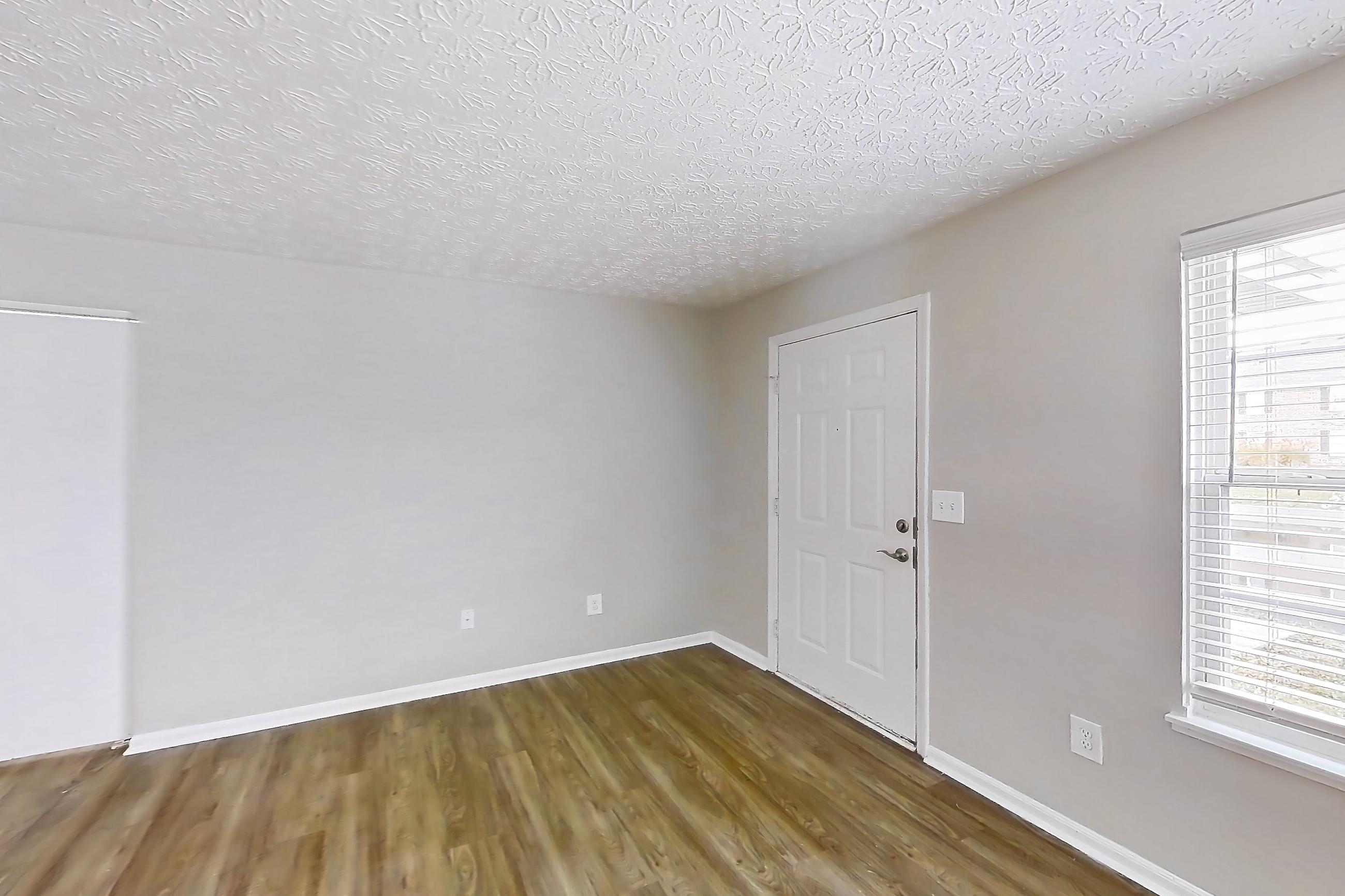 Living room with dark wood-finish flooring and light wood-finish flooring, Apartment 3642CCW at The Gardens Columbus