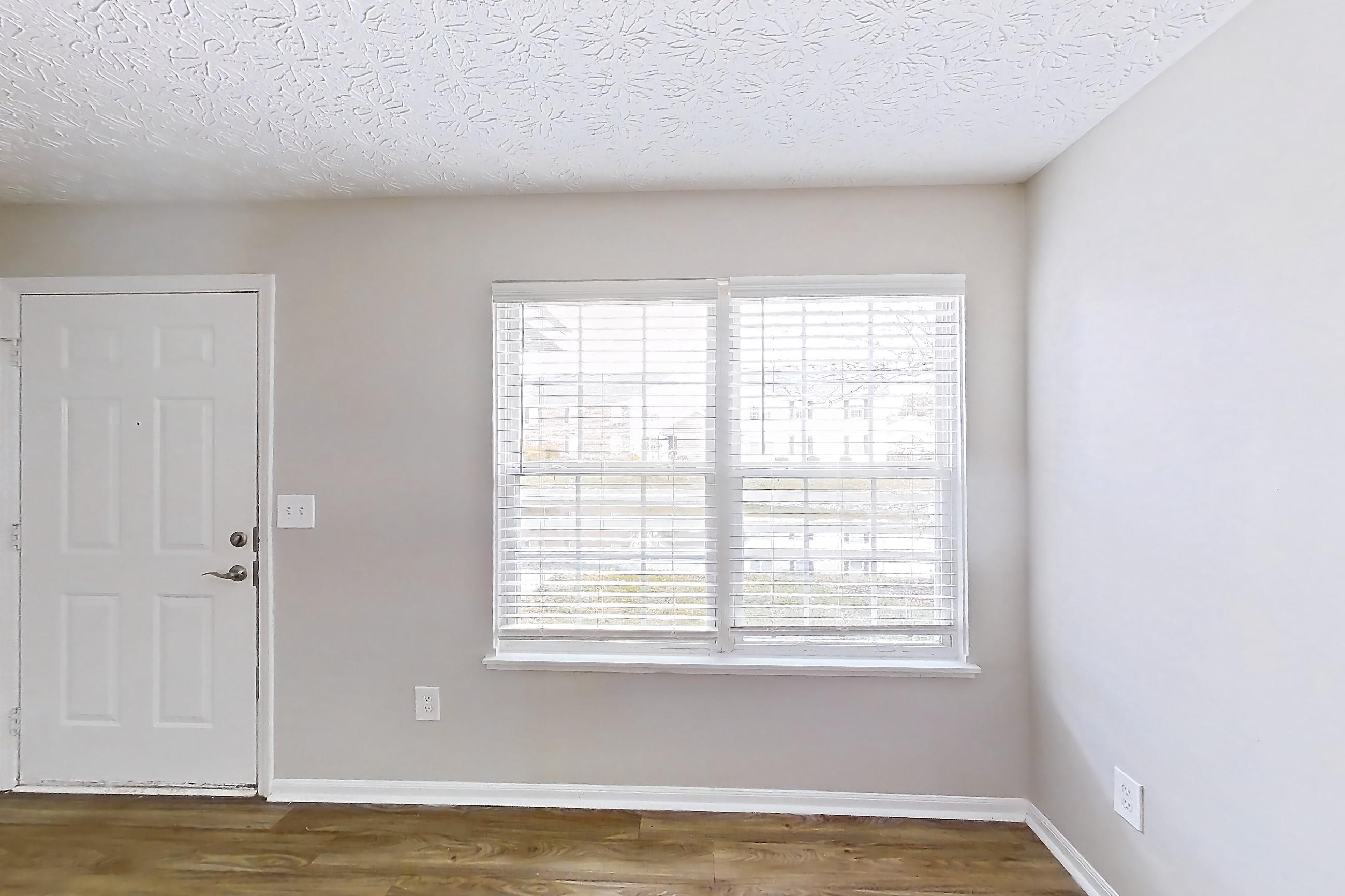 Living room with dark wood-finish flooring and light wood-finish flooring, Apartment 3642CCW at The Gardens Columbus
