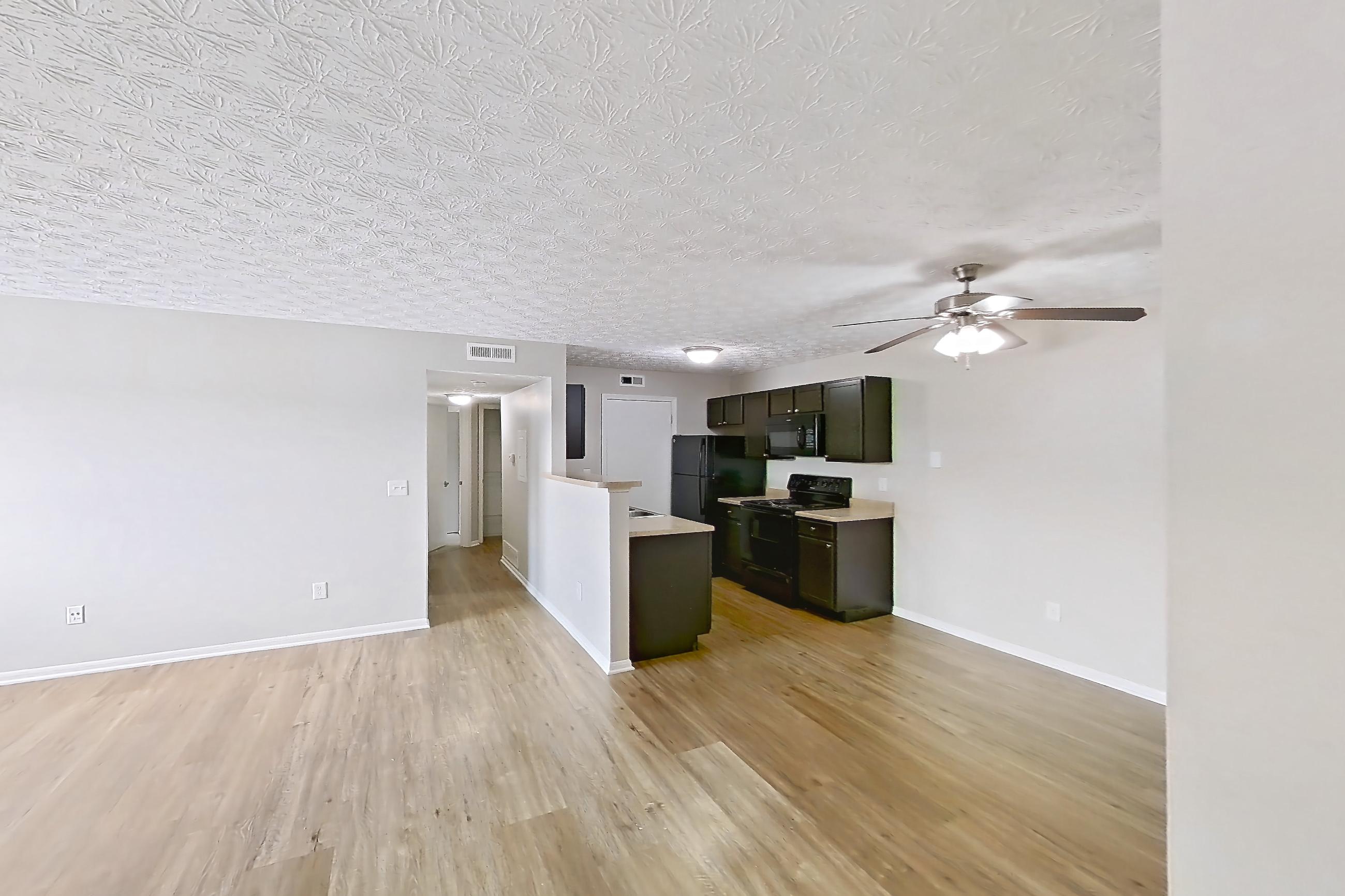 Living space with black appliances, electric range, light countertops, light wood-finish flooring, oven/range, and refrigerator, Apartment 3162BLD at The Gardens Columbus