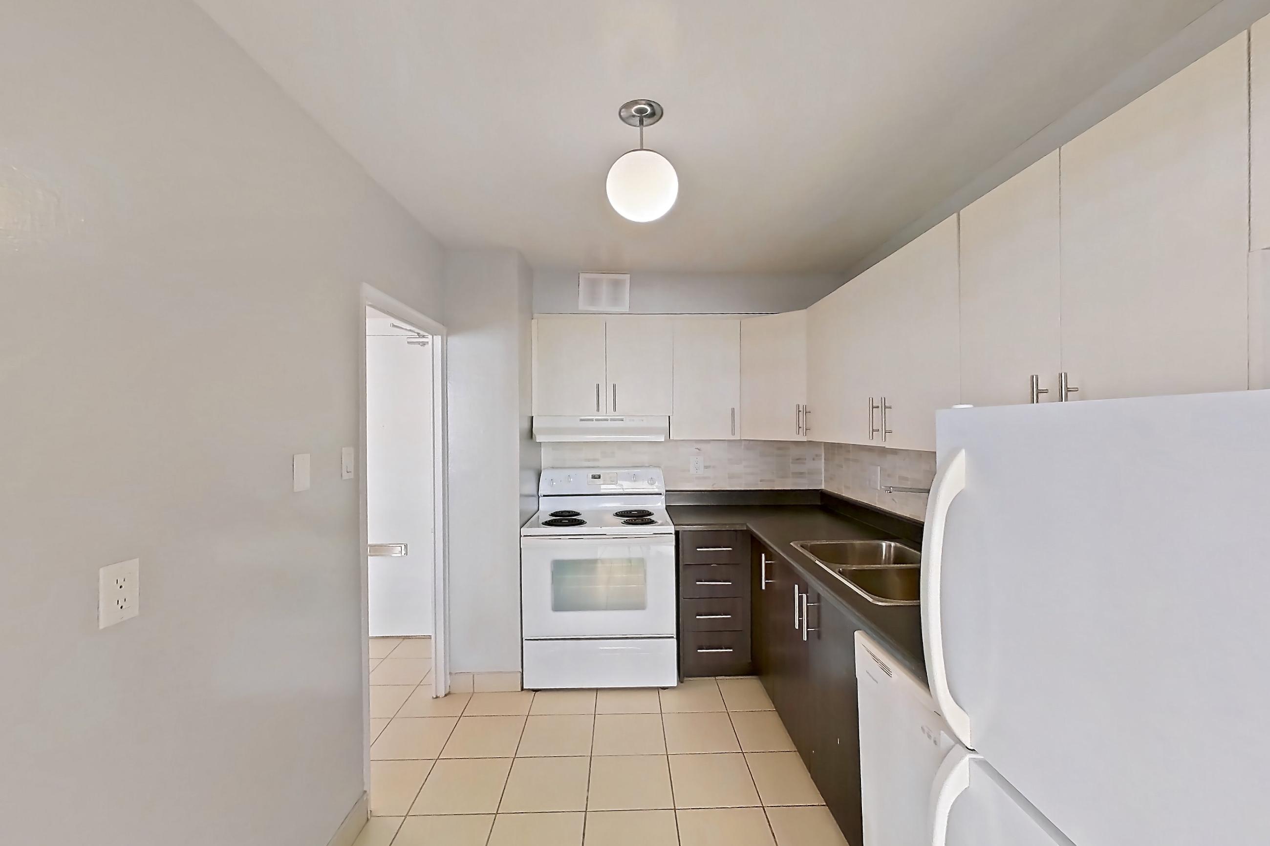 Kitchen in Apartment 1-1204 at Village Green, 2E floor plan