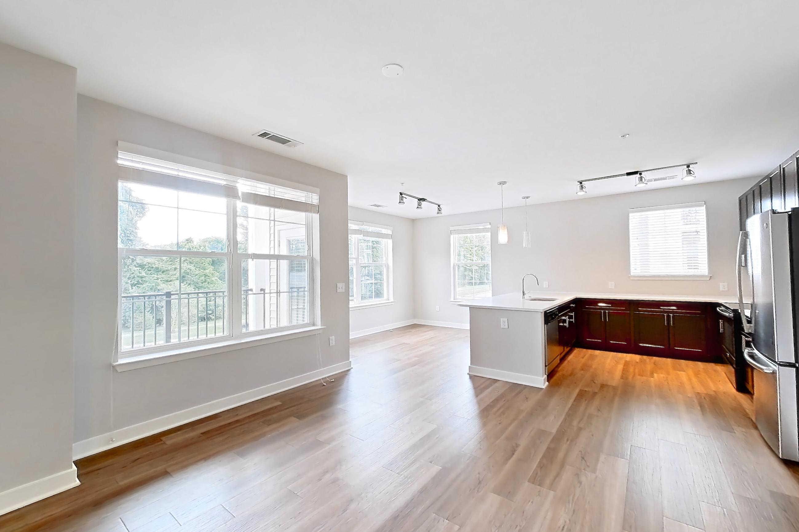 Living space with light countertops, light wood-finish flooring, oven/range, and stainless steel appliances, Apartment 10201 at Briggs & Union