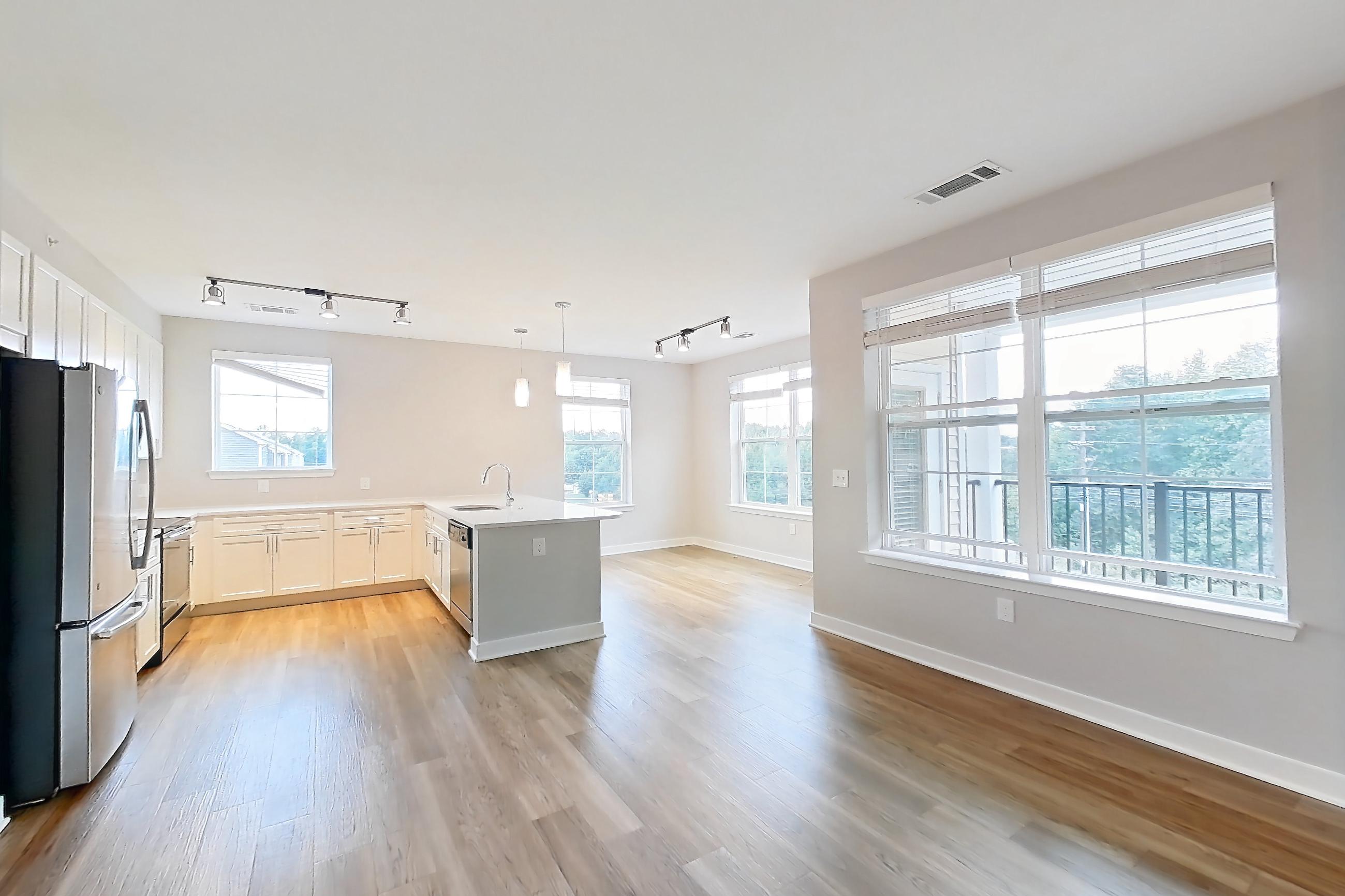 Living space with dishwasher, light countertops, light wood-finish flooring, oven/range, and stainless steel appliances, Apartment 1302 at Briggs & Union