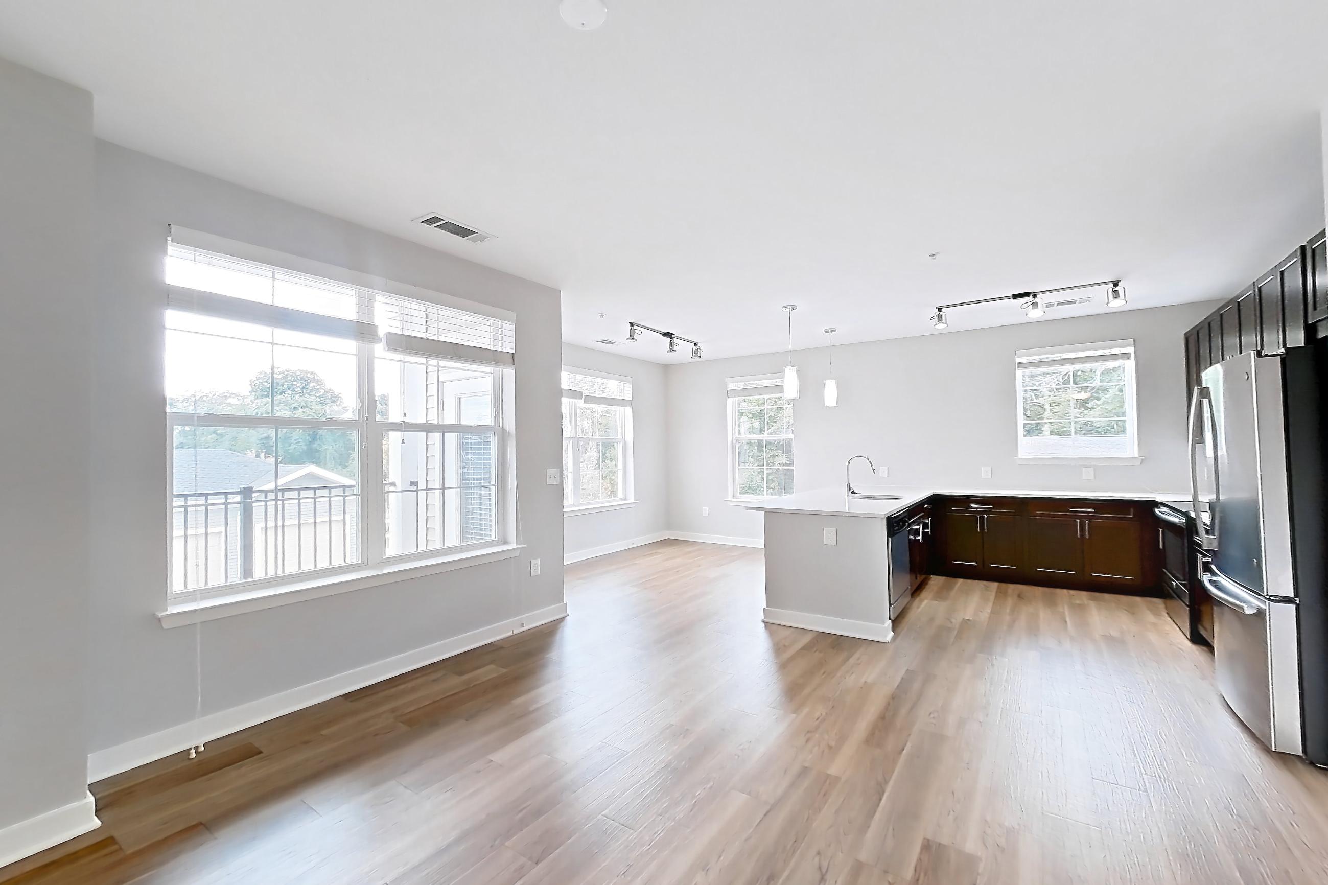 Living space with light countertops, light wood-finish flooring, oven/range, and stainless steel appliances, Apartment 13201 at Briggs & Union