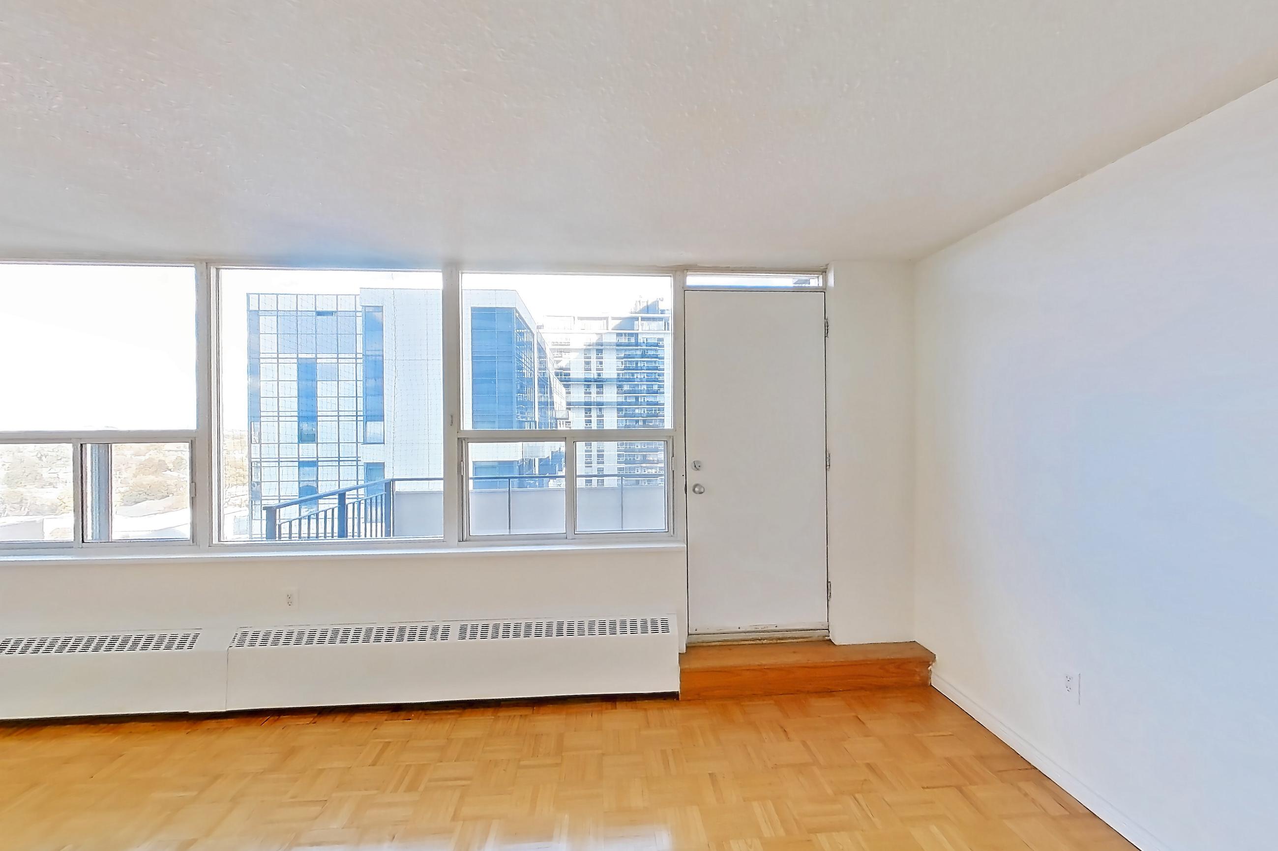 Living room with baseboard heating, light wood-finish flooring, and parquet flooring, Apartment 1611 at 77 Davisville