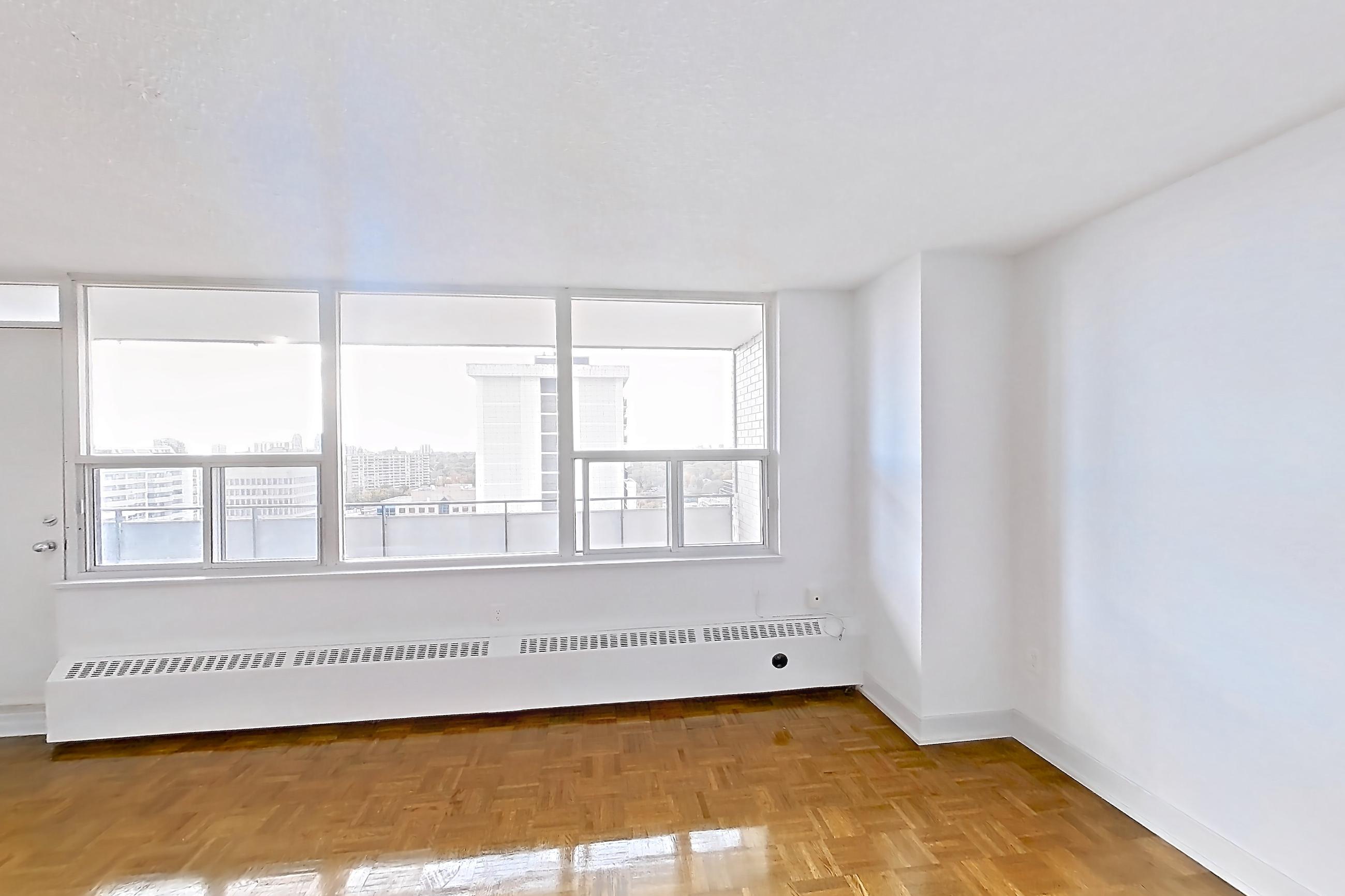 Living room with baseboard heating, dishwasher, light countertops, light wood-finish flooring, parquet flooring, refrigerator, and stainless steel appliances, Apartment 1918 at 77 Davisville