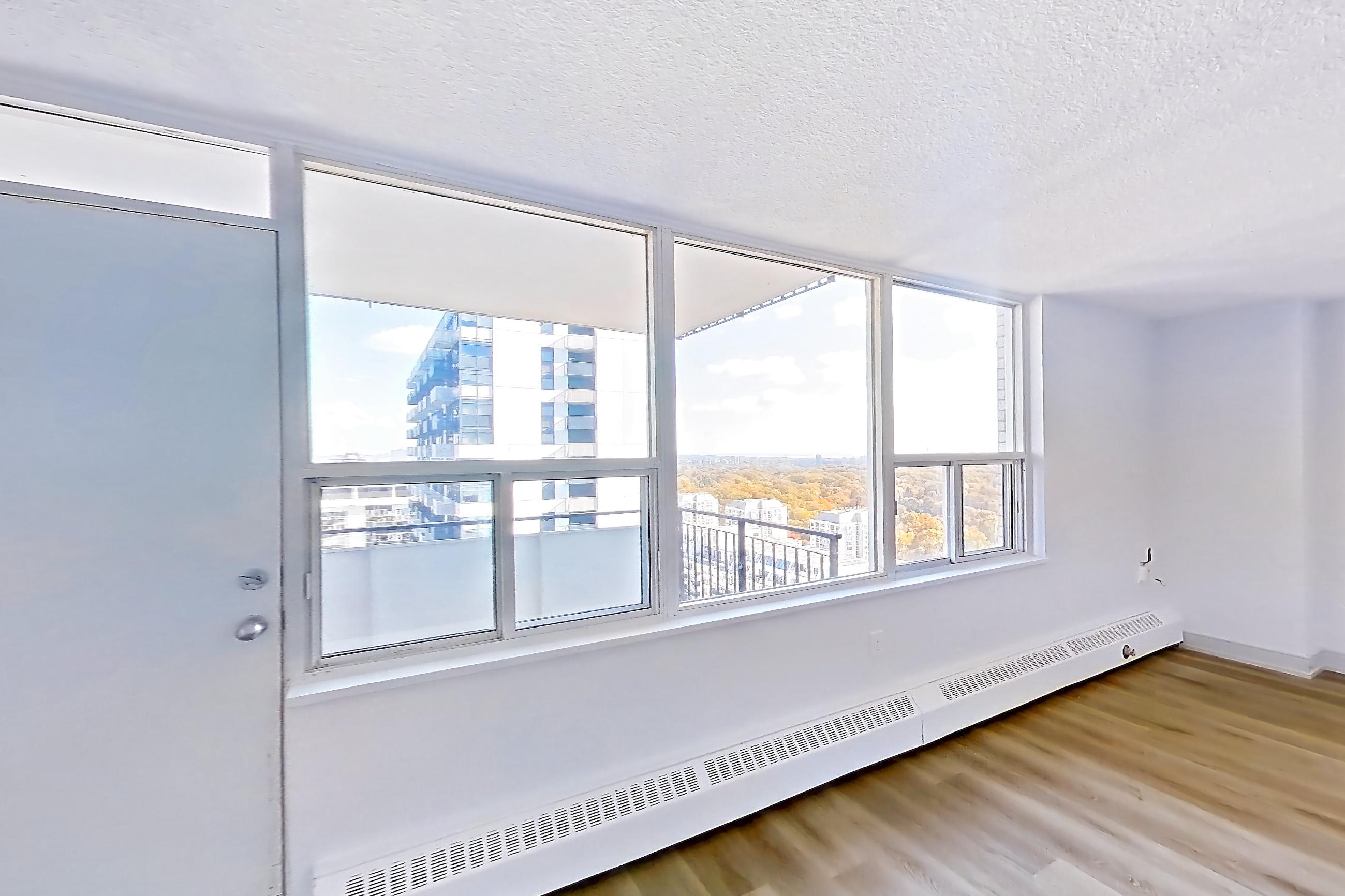 Living space with baseboard heating and light wood-finish flooring, Apartment 2805 at 77 Davisville