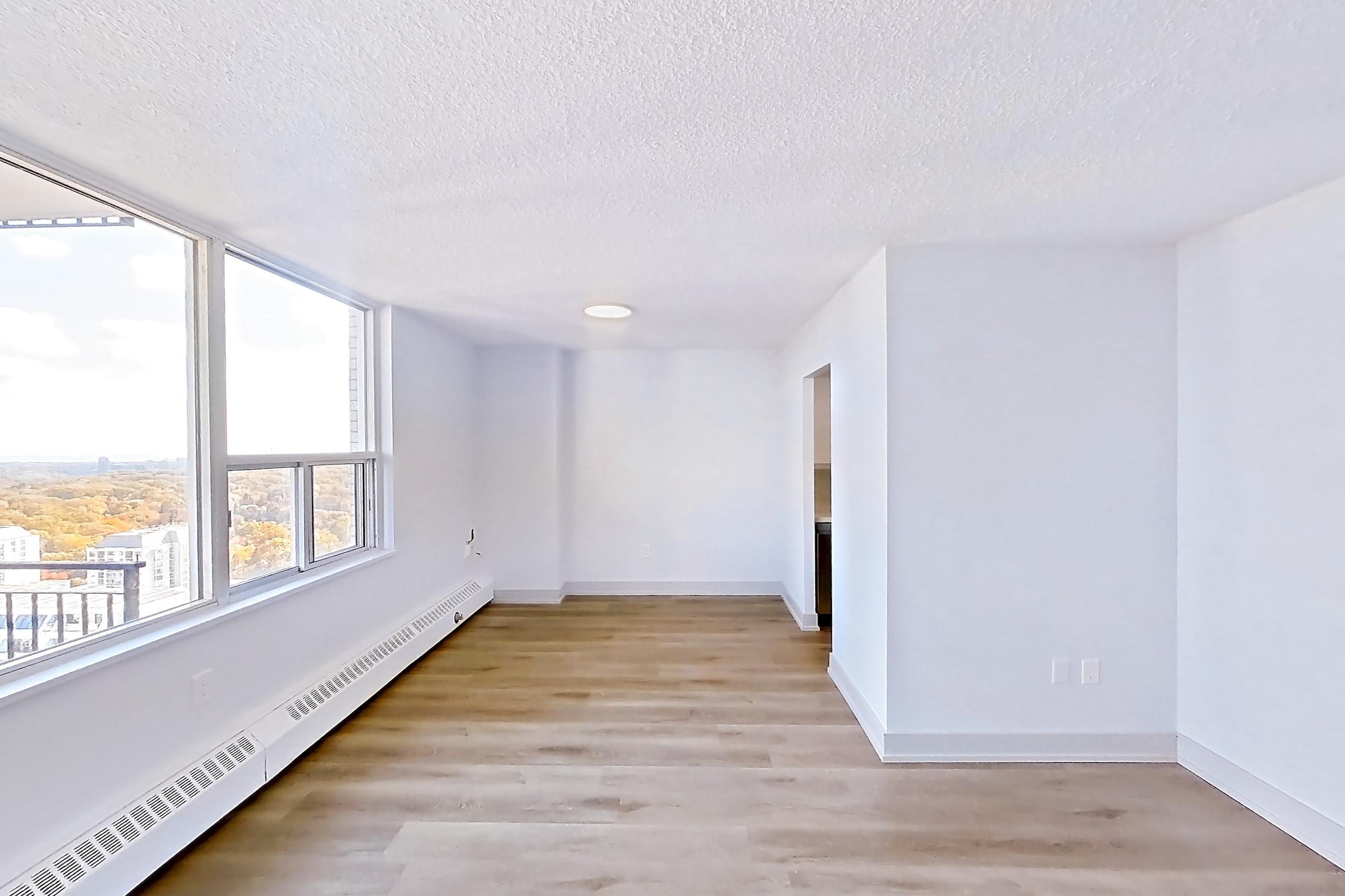 Living space with baseboard heating and light wood-finish flooring, Apartment 2805 at 77 Davisville