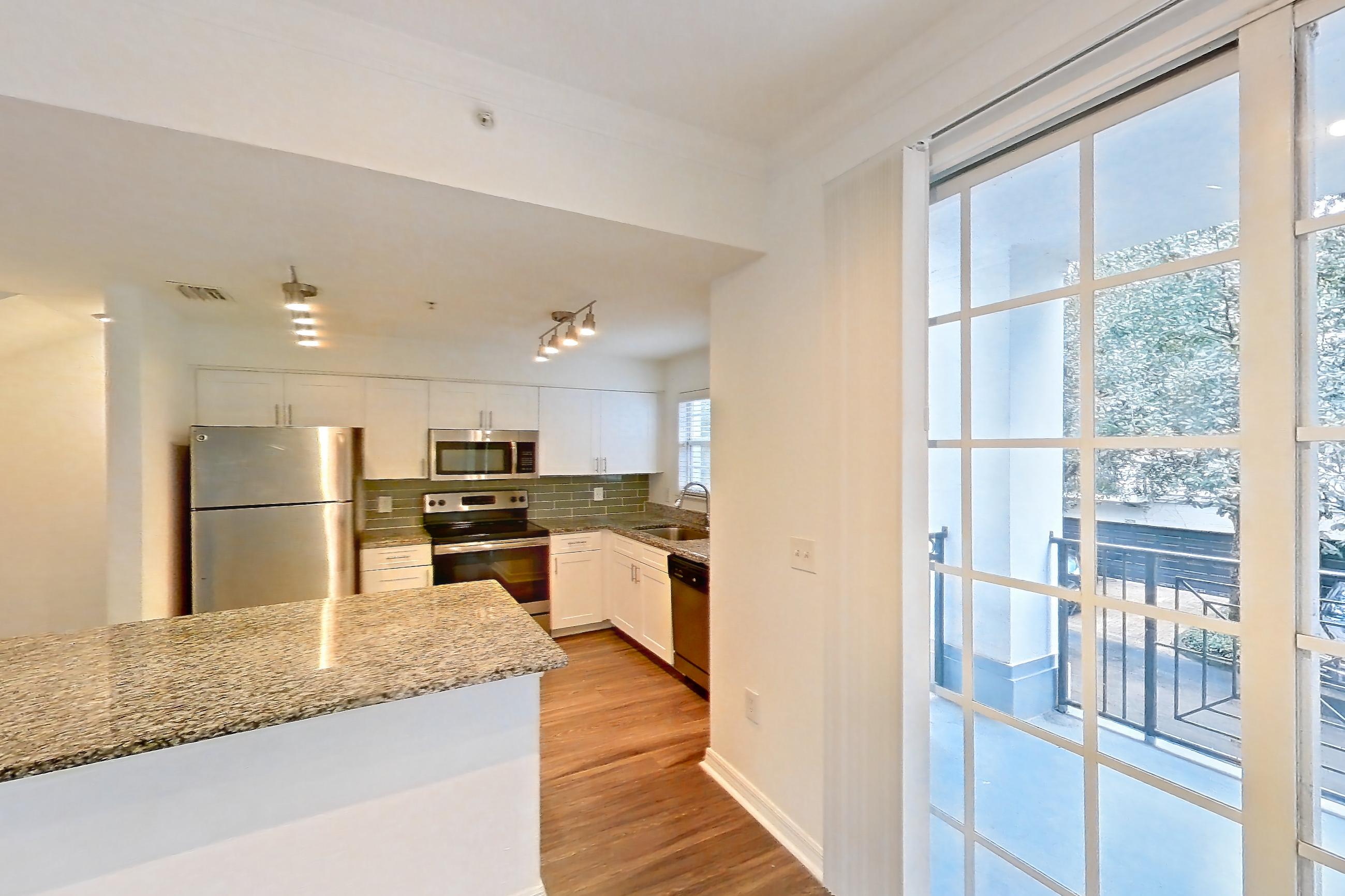Living space with dark wood-finish flooring, dishwasher, electric range, oven/range, refrigerator, and stainless steel appliances, Apartment 16-02573 at Solano at Miramar