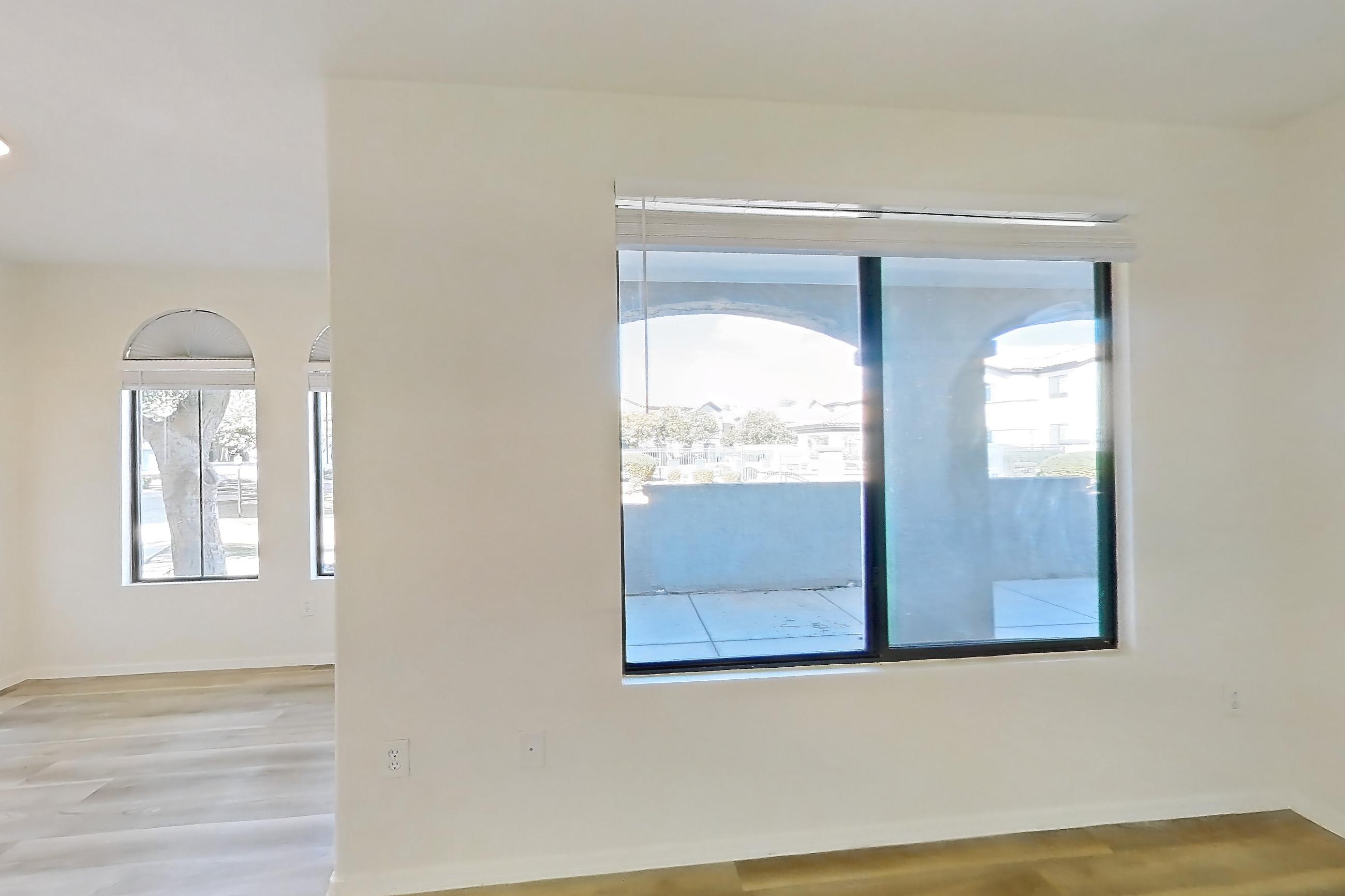Living room with light wood-finish flooring, oven/range, refrigerator, and stainless steel appliances, Apartment 1091 at Dobson 2222