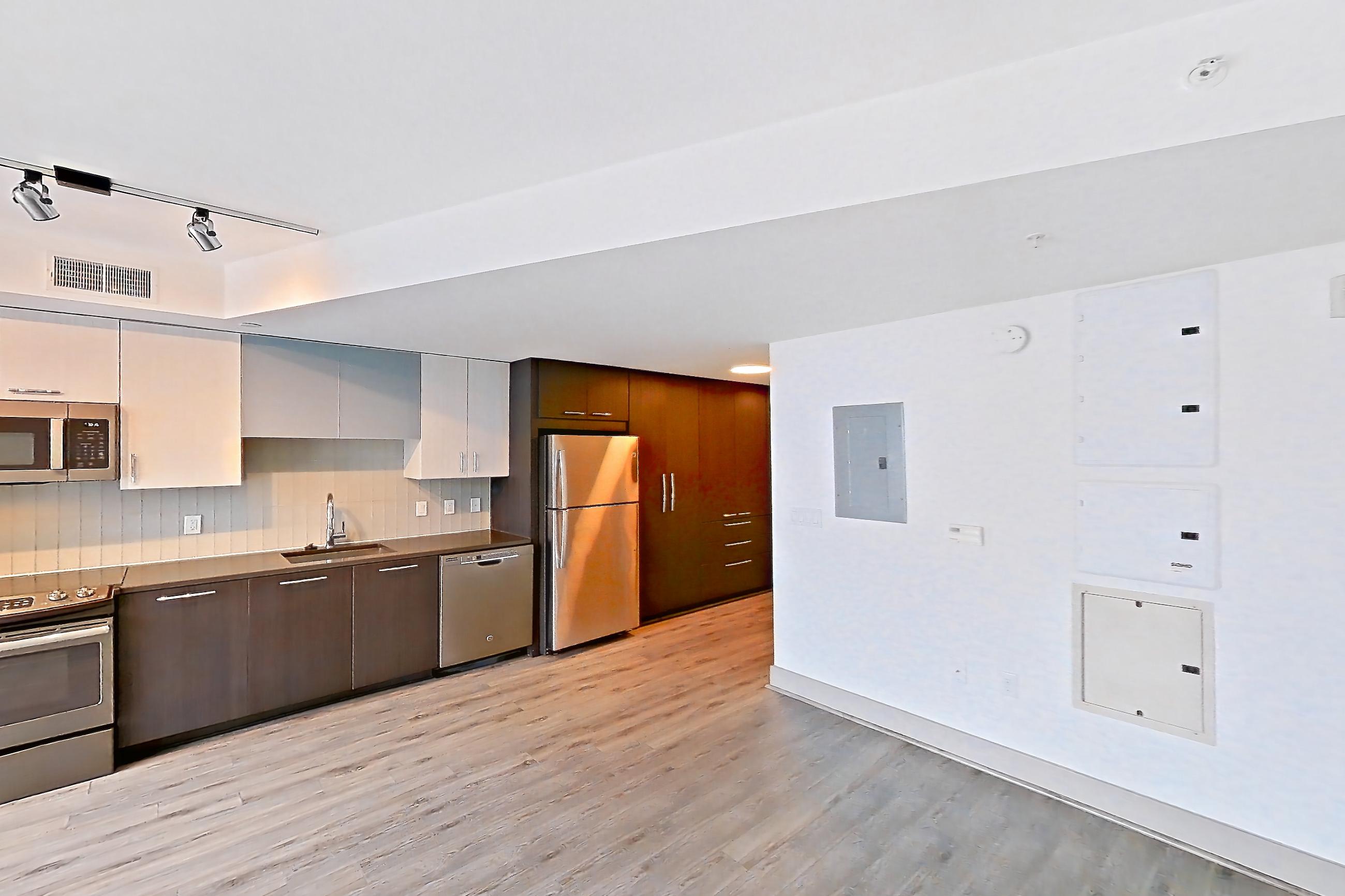 Living space with light wood-finish flooring, refrigerator, and stainless steel appliances, Apartment 1803 at Adaire