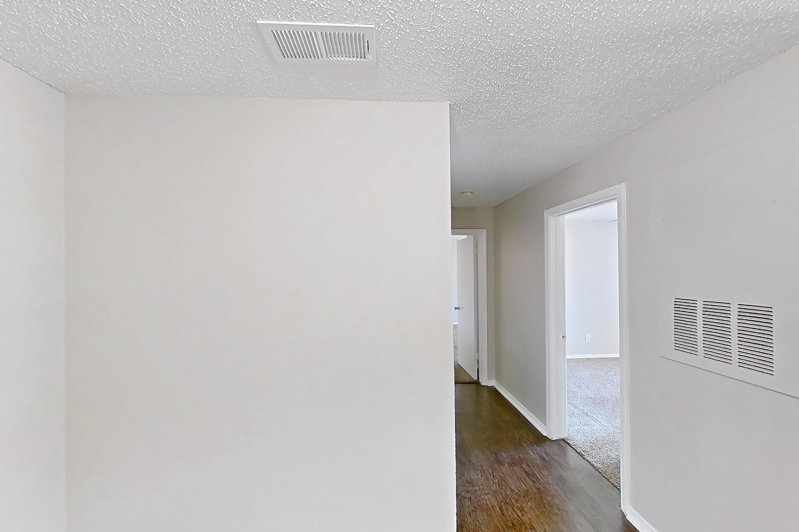 Dining room with dark carpet, dark wood-finish flooring, and fireplace, Apartment 1324 at Arbor Creek