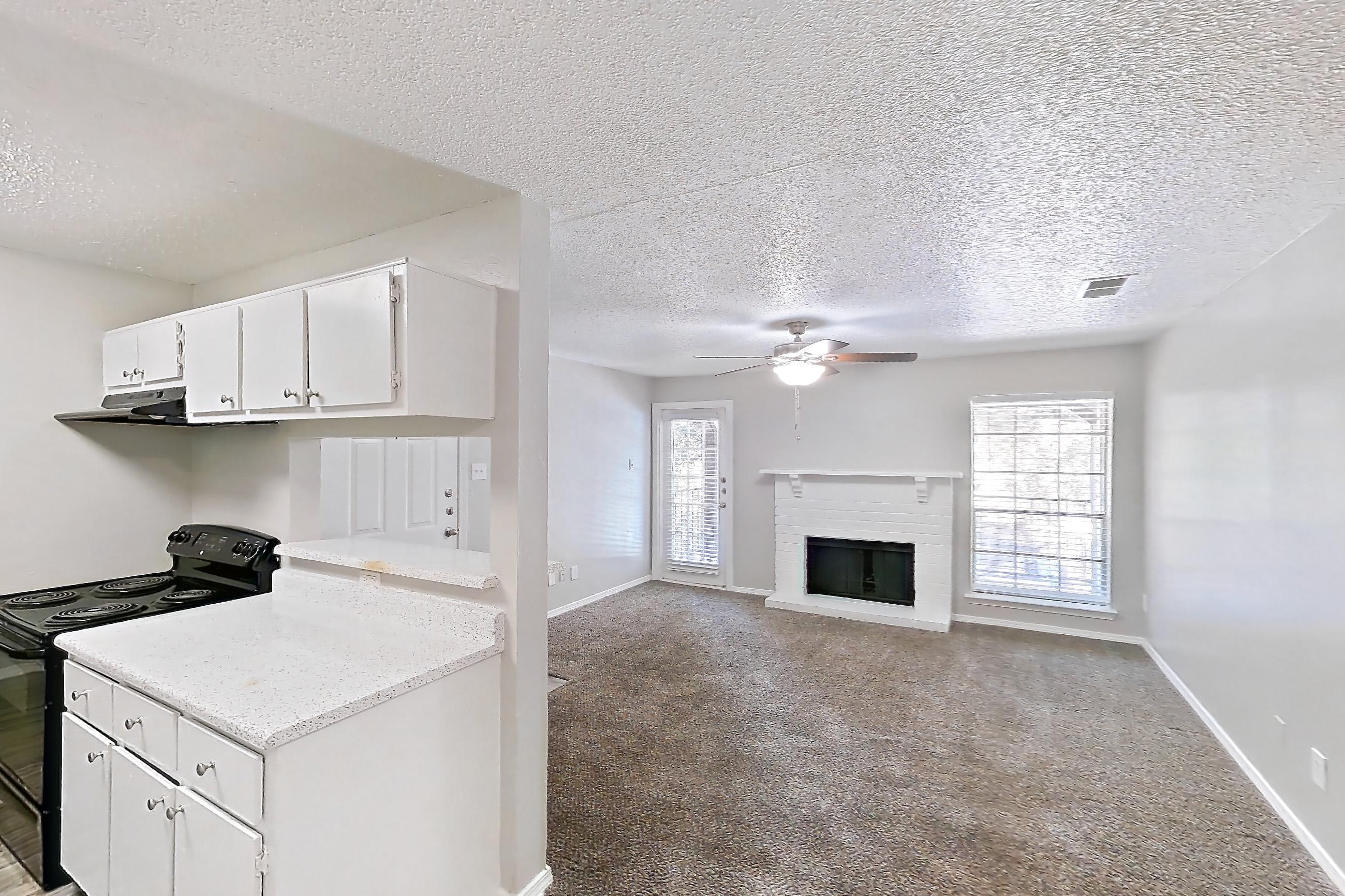 Dining room with fireplace, light carpet, and light wood-finish flooring, Apartment 322 at Arbor Creek