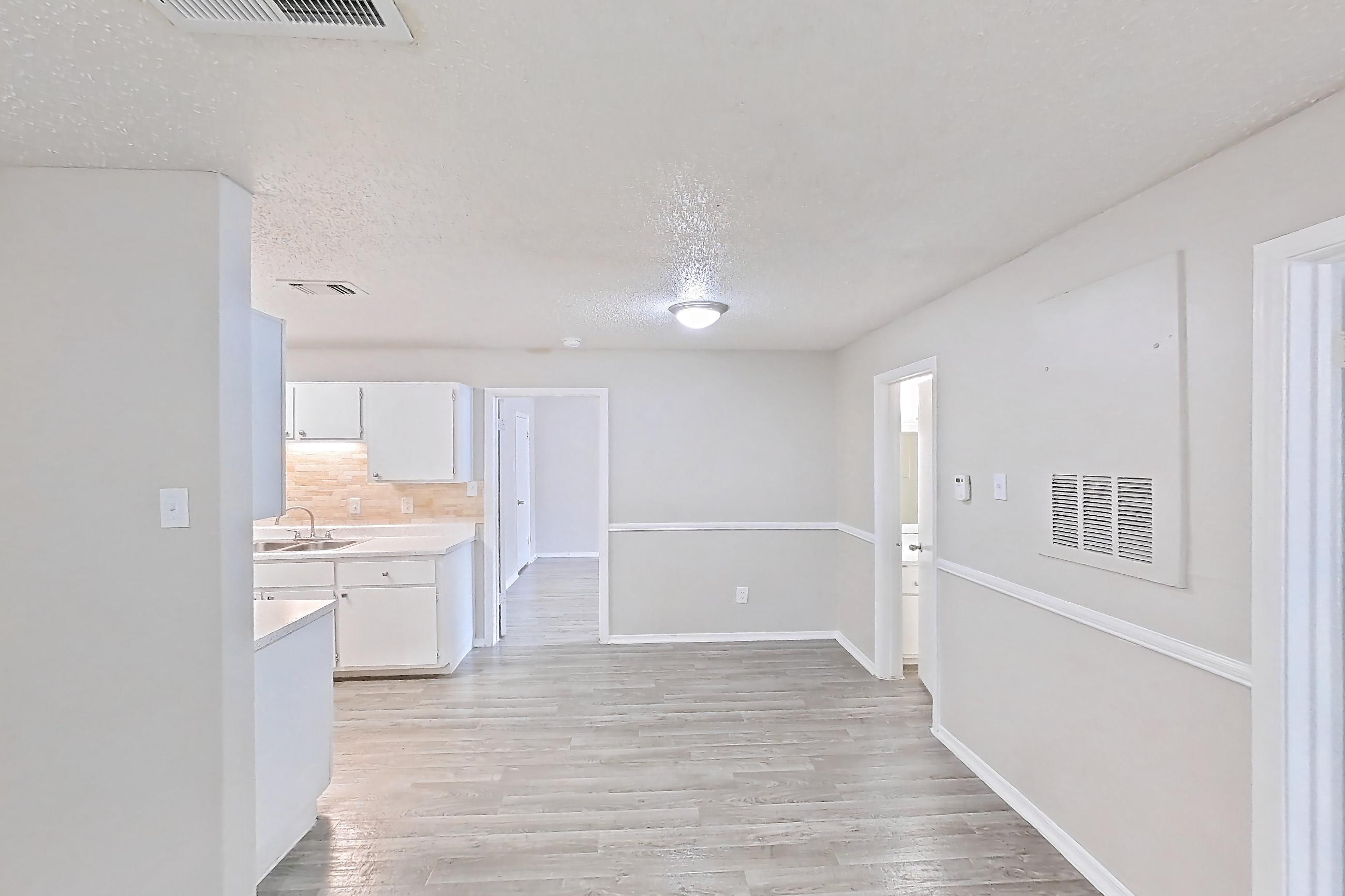 Living room with light wood-finish flooring, Apartment 1011 at Arbor Creek