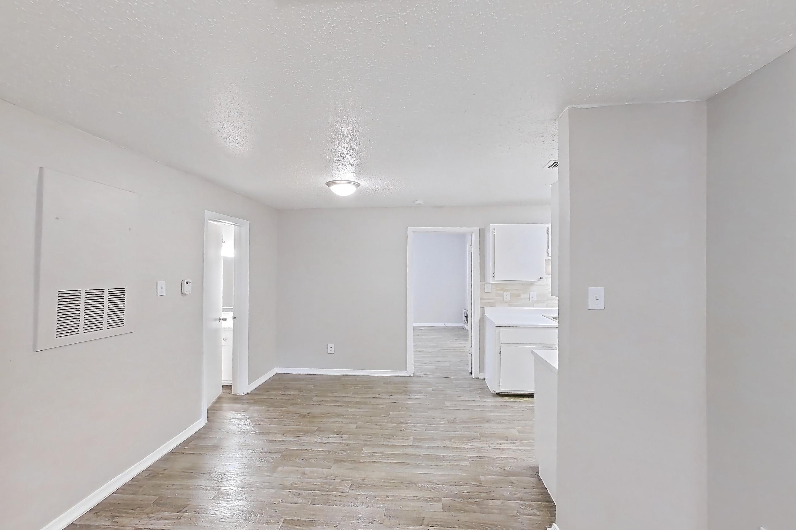 Living room with light wood-finish flooring, Apartment 122 at Arbor Creek