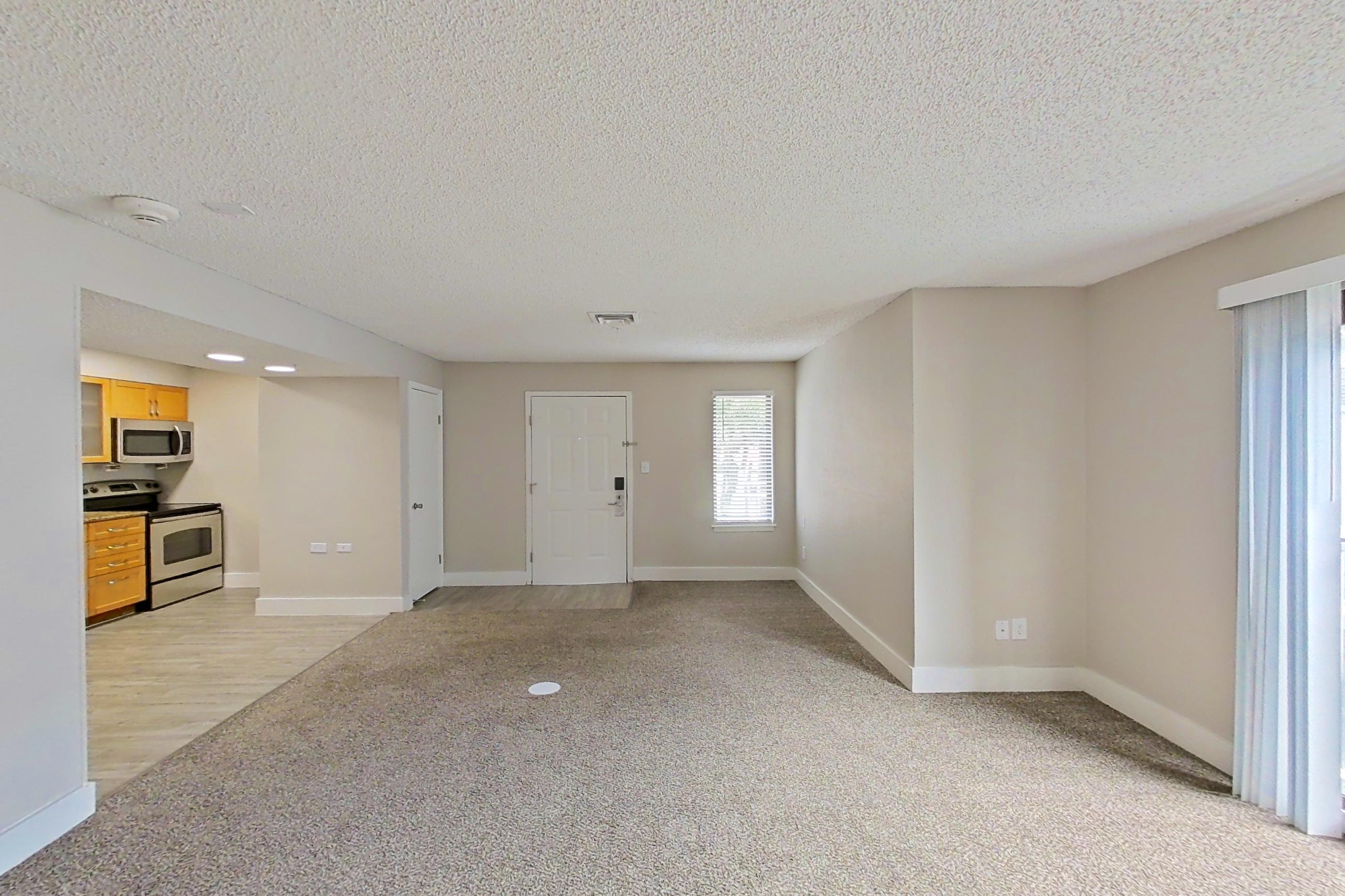 Living space with baseboard heating, oven/range, and white appliances, Apartment 224 at Pelican Lake