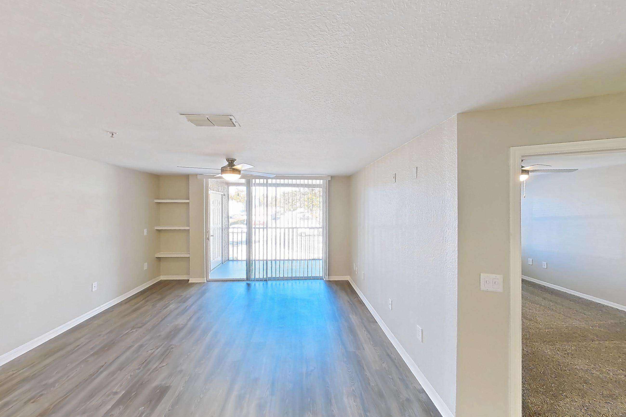 Dining room with dark wood-finish flooring, electric range, light countertops, microwave, oven/range, refrigerator, stainless steel appliances, and white appliances, Apartment 02-207 at Boot Ranch