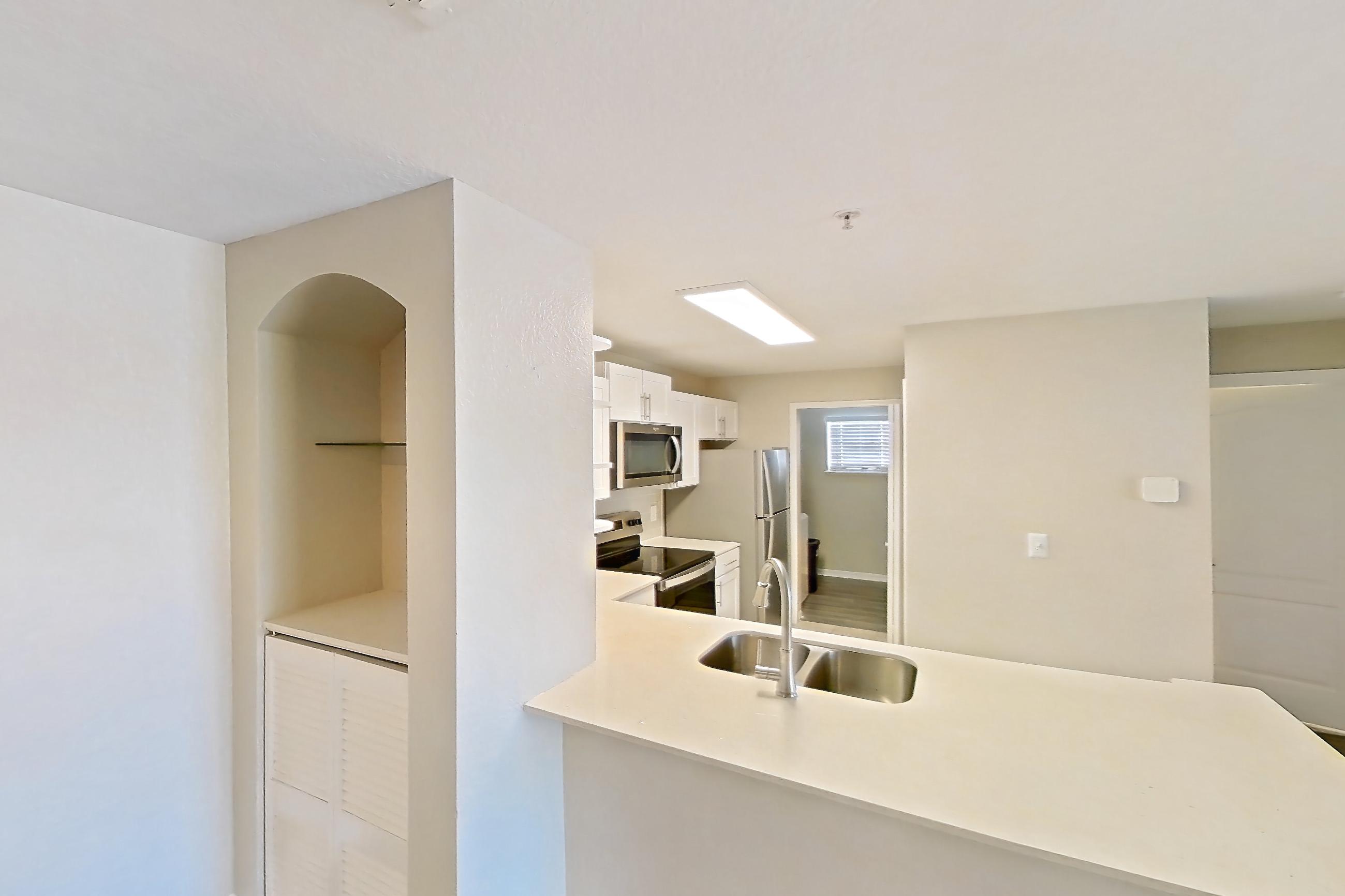 Dining room with dark wood-finish flooring, electric range, light countertops, microwave, oven/range, refrigerator, stainless steel appliances, and white appliances, Apartment 02-207 at Boot Ranch