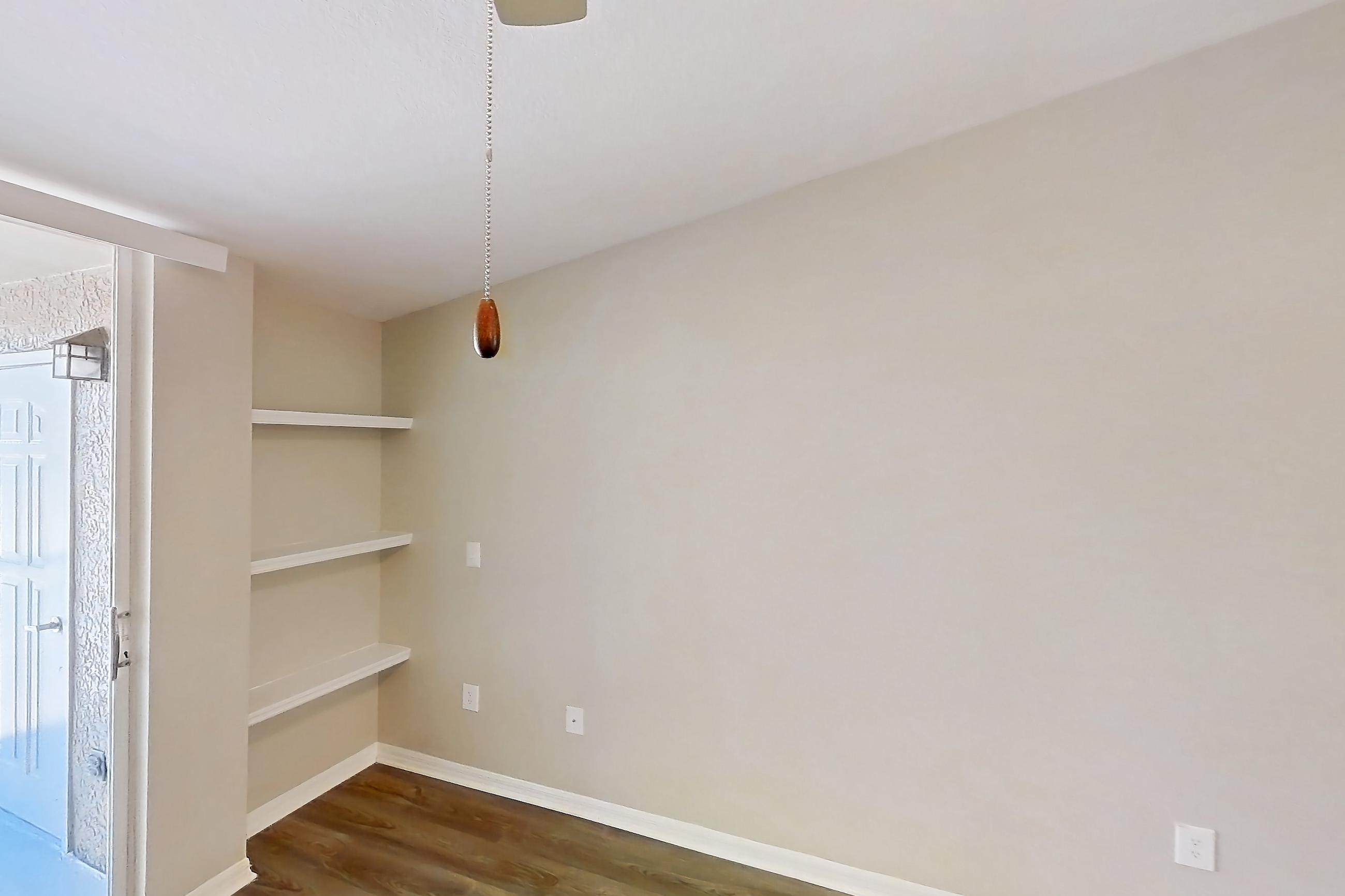 Living room with dark wood-finish flooring, Apartment 02-301 at Boot Ranch