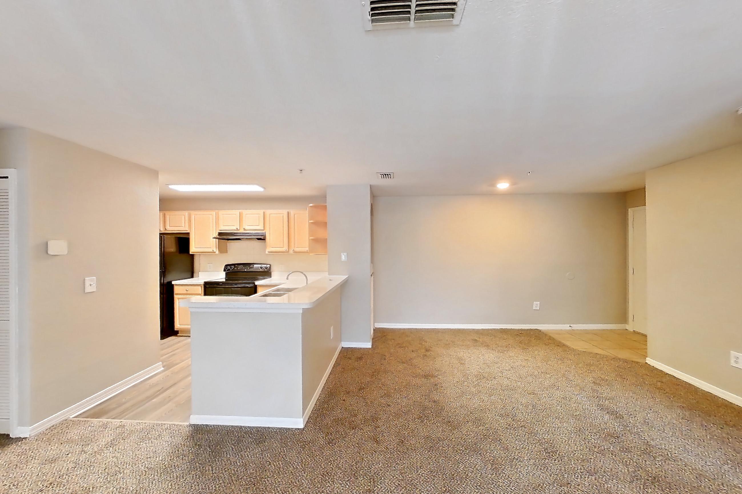Living space with black appliances, electric range, oven/range, and refrigerator, Apartment 05-205 at Boot Ranch
