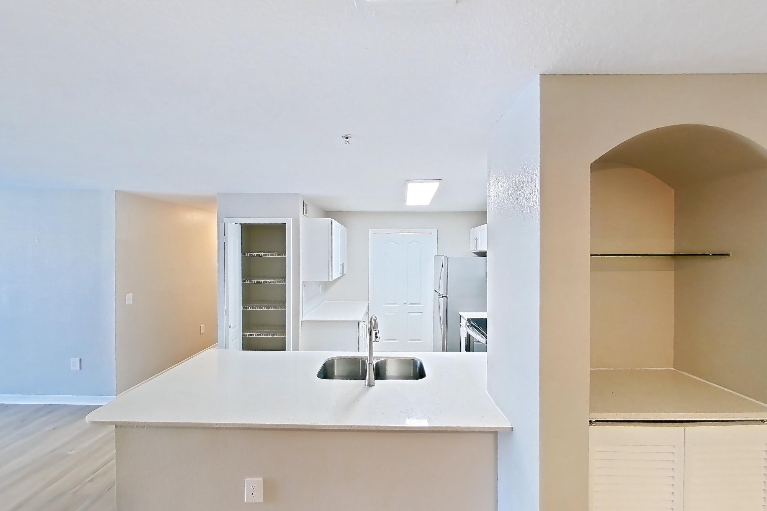 Living space with electric range, light stone countertops, light wood-finish flooring, oven/range, refrigerator, stainless steel appliances, and white appliances, Apartment 09-201 at Boot Ranch