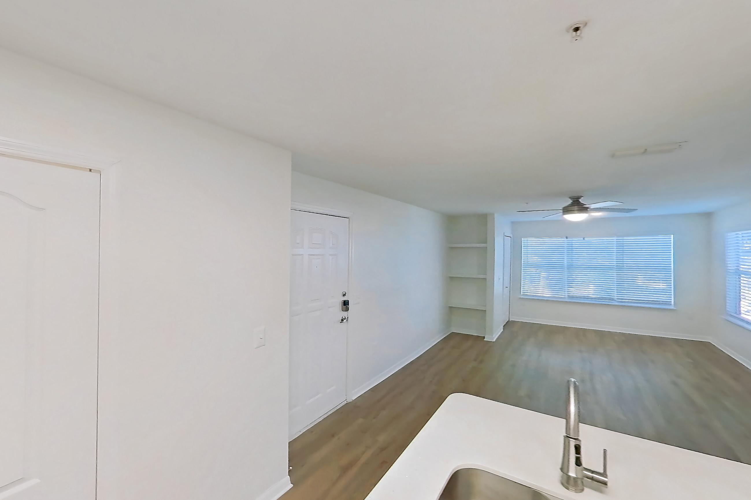 Kitchen with dishwasher, electric range, light countertops, light stone countertops, light wood-finish flooring, microwave, oven/range, refrigerator, and stainless steel appliances, Apartment 14-204 at Boot Ranch
