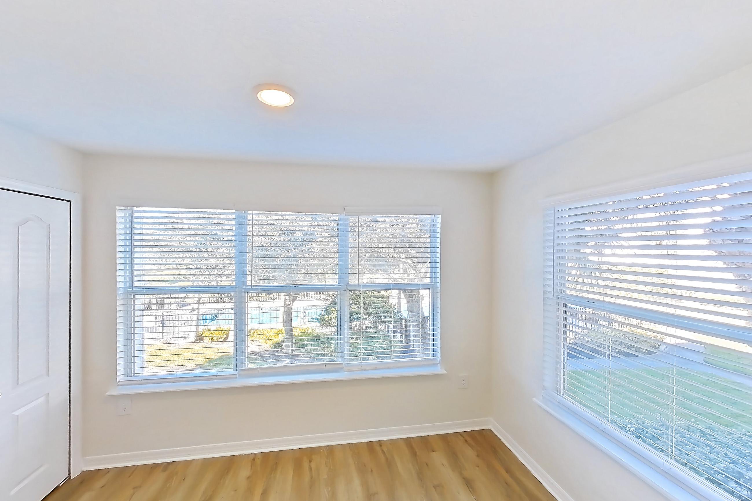 Living room with light wood-finish flooring, Apartment 14-204 at Boot Ranch